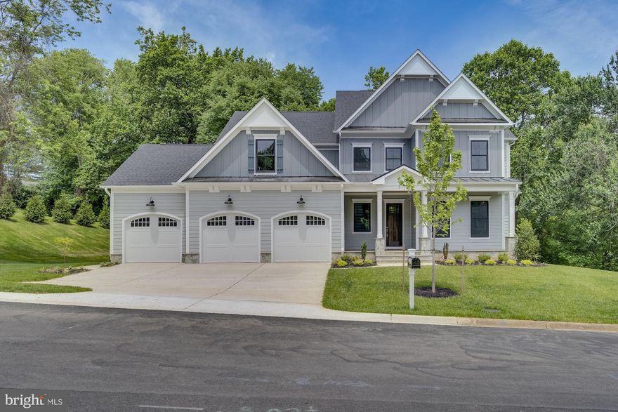 “One of a kind" 4 car garage,  brand new custom home built by Sekas in the sought after Cinnamon Creek community. This home has 6 bedrooms, 6.5 bathrooms, 6,527 square feet and is sited on a 0.47 acre lot. Beautiful craftsmanship both inside and out with a bright open floor plan that provides more than enough space for entertaining family and friends. Welcoming two-story foyer that leads to a grand family room and dining room. Exterior walls are 2x6 construction with 10’ ceilings on the main level and 9’ ceilings on the 2nd and lower level.  Gourmet commercial grade kitchen with quartz countertops, custom tiled backsplash, center island, 42" built-in KitchenAid French Door Refrigerator, and induction cooktop. Main level also includes a primary bedroom suite with large walk-in closet, office, laundry room, mudroom, and half bath. Upper level boasts a second luxurious owner's suite with spa-like ensuite bathroom and expansive walk-in closet, three additional bedrooms with ensuite baths, and a 2nd laundry room. Lower level features a recreation room with a wet bar, exercise room, bedroom with an ensuite bathroom, and storage room. Outdoors has a spectacular heated screened-in porch and a large elevated composite deck both providing an absolutely spectacular view of a Wolftrap Creek tributary.  The back yard is large enough for a trampoline and swingset. This home also features an oversized four car front-load garage that can accommodate either a large workshop or up to 5 cars and includes a Tesla Gen3 charger. Charming covered front porch with lots of curb appeal and concrete driveway with ample room for cars to park.  Walk to Wolftrap Amphitheater. Conveniently located near Wolf Trap National Park for the Performing Arts, downtown Vienna, W & OD Trail, Metro, Tysons, and DC.