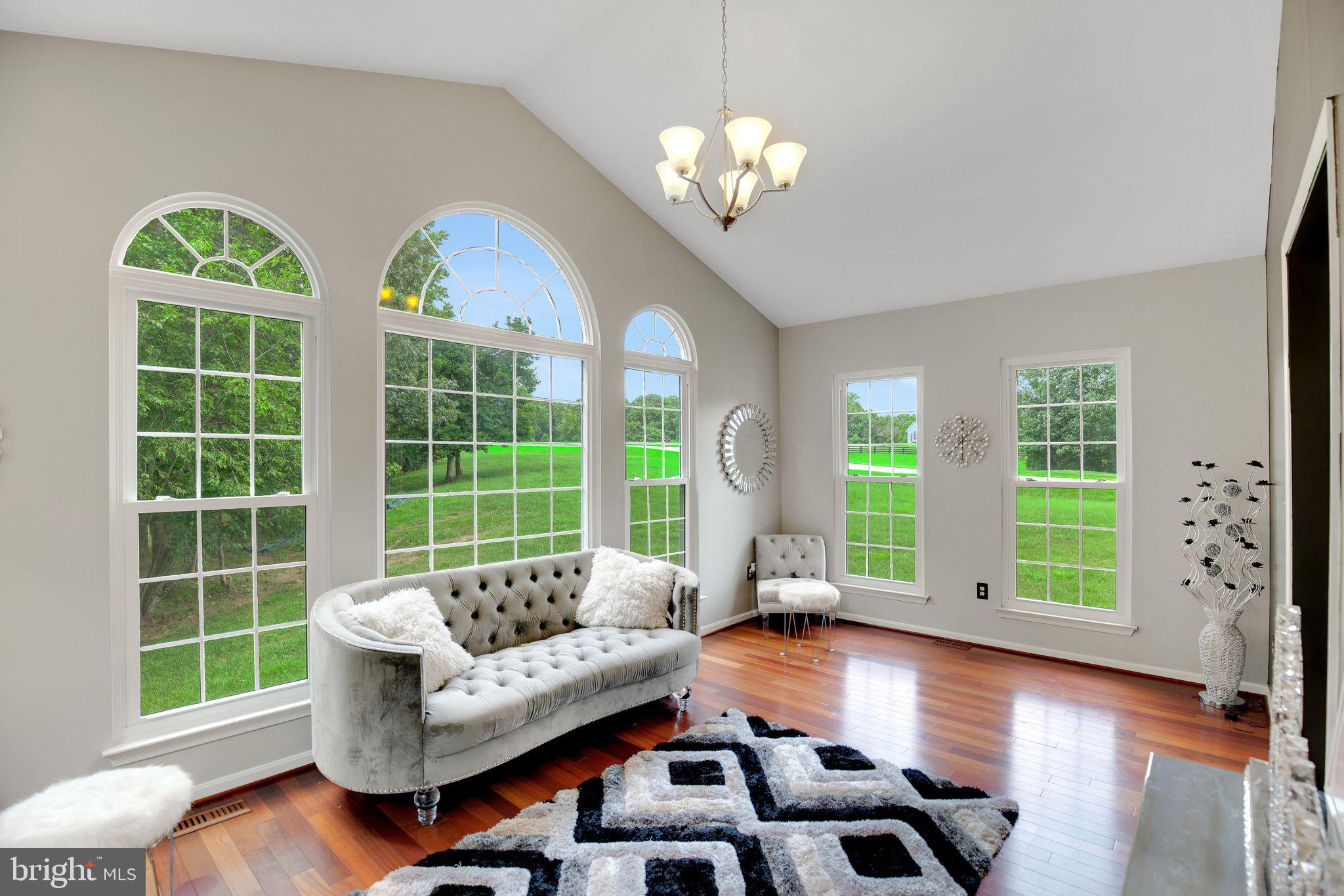 This impressive brick-fronted colonial home spans 6,398 square feet, featuring 7 bedrooms and 5 bathrooms on a 3.4-acre lot bordering a forest with a creek. Highlights include a private in-ground pool with spa, and recent upgrades, including a dual-zone heating and air conditioning system by Goodman in November 2023, all 53 windows were replaced in 2019 with double-hung Power Windows, many on the westerly side are tinted for energy efficiency. The roof was upgraded with architectural shingles in 2017. The grand foyer welcomes you with two-story ceilings and a wrought iron and hardwood staircase. The main level showcases Brazilian cherry hardwood floors and includes an office/study, access to the oversized 3-car garage, and a full bathroom. The semi-open concept living area combines a living room, dining room, and two sunrooms with vaulted ceilings. The gourmet kitchen boasts granite countertops, a Viking gas double oven, and an expansive island. The cozy sunken family room features a wood-burning fireplace. Two stairways lead to the second floor. Here you’ll find five bedrooms and three full bathrooms. The primary suite includes tray ceilings, a walk-in closet, and an ensuite with a soaking tub, oversized step-in shower, WC, and two vanities. A second primary bedroom with large walk-in closet has its own ensuite bathroom along with two built-in shelves that cleverly conceal attic storage spaces. The remaining 3 bedrooms share a full bathroom with a solar tube. A laundry room with sink, counter, and cabinets is also located on this level. The basement features an open floor plan with a recreation room, kitchenette area with wet bar, mini fridge, columns, dining area, waterproof LVP flooring, and a sunken living area. The movie theater with surround sound and arena-style seating is a big win. There are two additional bedrooms - one that can be your exercise room/office/hobby room and one with built-in cabinetry that could also double as office/hobby room. There is a room for storing wine with mini fridge, two more storage rooms, and a full bathroom with a 2nd laundry area. Outside, enjoy expansive decks, a paver patio, and a paver trail leading to a state-of-the-art private pool and spa with a waterfall for added ambiance. The heated pool is equipped with a built-in anti-freeze system. Truly, this pool area is a tranquil place. The property also includes two owned 500-gallon propane tanks: one for the home and backup generator, and another dedicated to the pool. A shed near the pool was added around 2020.