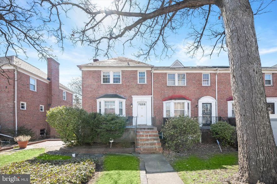 Welcome to this inviting three bedroom, two bathroom end-unit brick rowhome with three levels of living space. As you arrive, a front porch greets you overlooking the lawn, along with a brick side patio for spending time outside. Inside, the front living room boasts a sun-filled bay window, a wood-burning fireplace and hardwood floors that continue into the dining room. The kitchen has brand new flooring and a versatile breakfast nook that could also be used as a pantry, with balconies on either side that are perfect for grilling, dining al-fresco or simply lounging. Upstairs, each of the three bedrooms also feature hardwood floors, with a full bathroom that has a tub shower. Downstairs, the lower level offers endless potential to meet your needs, with a recreation room highlighting a second wood-burning fireplace. The second bathroom on this level has a walk-in shower, and the utility room has laundry and access outside. A one car garage adds convenience, with additional parking in the driveway.