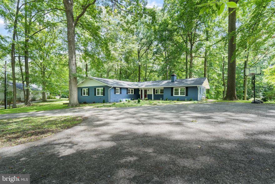 Fully renovated Mid-Century in Pikesville, nestled quietly on a large flat lot, approx 4600sf of living space & surrounded by wooden greenery is waiting for you to call it your very own. As you drive up the circular driveway, spacious for plenty of guest parking, prepare yourself to be wowed by all this home has to offer. A gorgeous white carrara marble-style foyer, crown molding, recessed lighting, and the open floor plan with gleaming hardwood floors throughout are just a few of the many details you’ll notice as you enter. The sitting area is bright and airy featuring a wood-burning fireplace, perfect for cozying up on chilly evenings. Prepare and cook your favorite meal in the kitchen, embellished with stainless steel appliances, modern cabinetry, large pantry and quartz countertops and backsplash. French doors open to a vast office space or library with built-in shelving and a large closet for extra storage. Adjacent to the office is the half bath which leads to the laundry room.  A gorgeous living room and dining room area dons a stacked stone electric fireplace as a focal point and adds a feeling of modern luxury. Entertain family and guests in the spacious dining area, with room for a large table.  The primary suite is spacious, complete with a generous amount of closet space, including a custom walk-in closet and double wall closets. The ensuite bath gives you a spa-like retreat with stylish fixtures, granite topped dual sink vanity and ceramic custom tile work. The additional bedrooms are sized perfect for family and friends. The hall full bath is finished with fashionable fixtures and dual vanity. The finished basement is ideal for a large recreation area, 2 additional guest bedrooms and a full bathroom, with plenty of storage space and it’s own access to outside.  Step out onto the new rear patio with a trellis, great for BBQs and endless summer fun. There is a new well pump, filter and softener, two new HVAC systems, new roof and more that make this home a true dream come true and it could be yours! Most conveniently located mins from 83 & 695. Quick access to Falls Rd, Greenspring Ave, Quarry Lake and downtown Schedule your showing today!