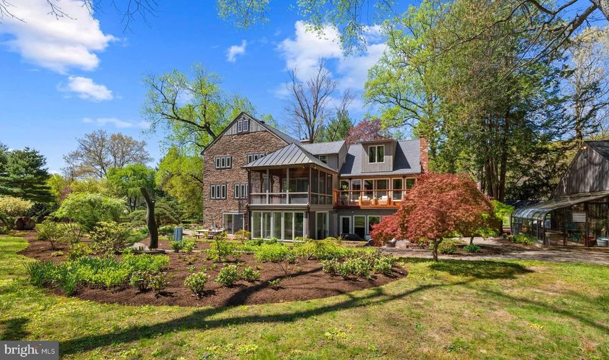 Set on over six acres of private Delaware River frontage, this exceptional Bridge One estate offers a rare, resort-caliber setting where landscape, architecture, and serenity come together in complete harmony. With grounds that extend to the water’s edge, the property unfolds as a series of beautifully composed outdoor spaces, expansive lawns, mature trees, and meandering garden paths, creating a sense of tranquility and retreat just minutes from New Hope, Lambertville, Stockton, and Frenchtown. The main residence is both distinguished and inviting, blending classic materials with a creative floor plan designed for elevated everyday living and refined entertaining. Five bedrooms and 3.5 baths are complemented by a variety of gathering spaces, including a dramatic great hall/game room, an expansive and character-rich setting ideal for recreation or entertaining all while offering picturesque garden views. Two well-appointed kitchens provide exceptional flexibility for hosting, extended stays, or multi-generational living, while a dedicated office offers a quiet, functional space for work or study. Large windows and doors throughout the home invite natural light and frame the surrounding landscape, while the primary suite serves as a true retreat, featuring peaceful river views and access to a private deck. The outdoor experience is equally compelling. A beautifully sited in-ground pool serves as a focal point for summer living, accompanied by a thoughtfully designed pool house complete with a full bathroom and kitchenette, perfect for seamless indoor-outdoor entertaining and extended days by the water. Pathways weave through curated gardens and open green spaces, offering moments of quiet reflection and connection at every turn. Enhancing year-round enjoyment, an indoor pool and sauna provide a private wellness escape regardless of season. A detached garage with a fully equipped apartment above provides a private, comfortable retreat for guests, extended family, or caretakers. In addition, a separate riverfront studio building, complete with utilities and set in its own peaceful and panoramic location, offers an inspiring space for creative pursuits, wellness, or quiet work. Every edifice within the estate now boasts a new roof, coupled with a considerable allocation of resources for landscaping and tree removal. This is a property that lives like a private riverside resort, expansive yet intimate, luxurious yet serene. Offering a rare opportunity to experience waterfront living in one of the region’s most picturesque and sought-after settings, 6 Bridge One is your home to Retreat, Relax, and Restore.