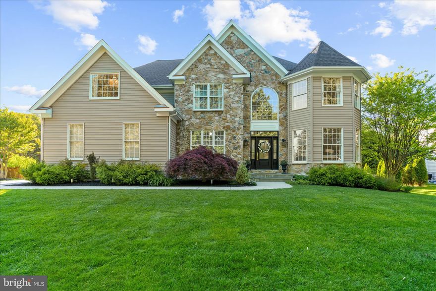 Welcome to your dream home, located just off route 50 in the quiet, desirable, cul-de-sac community of Chesapeake Preserve. Sitting on 0.61 acres, major improvements have been made throughout the home to include: two new HVAC systems, new attic ductwork system, new roof, new insulation, new sump pump, completely renovated landscaping with a professional designer, a renovated finished basement, and a renovated primary bath. Filled with natural light and hardwood flooring throughout, the open floor plan with 18’ ceilings sets the stage for an inviting home that balances intimate living spaces and entertaining ease. A show-stopping stone fireplace grounds the main floor, flanked by windows up to the ceiling. The updated kitchen is fit for serious cooking featuring new, stainless steel appliances and granite countertops. The adjacent mudroom contains a beautiful yet functional laundry area, leading to a 2-car garage with a level 2 EV charger. A main-floor bedroom offers flexibility for an office or additional sleep space. Upstairs, the spacious primary suite leads to a stunning, luxurious ensuite. Newly renovated, it features double vanities, a separate water closet, a large glass-enclosed shower, and a picturesque freestanding tub that beckons you to relax. Two additional bedrooms share a jack-and-jill bathroom and a fourth bedroom features a private ensuite. The expansive, renovated basement offers additional space for entertaining and hosting, a 4-piece bathroom, a home gym, and generous storage. In the back yard, an entertaining haven awaits. A covered back porch seamlessly leads to a generous deck with a jaw-dropping view of the oasis beyond - a beautiful, in-ground, gunite, salt water pool with a waterfall, surrounded by an expansive patio and meticulously designed landscaping. A shed offers bonus storage space. Enjoy nature along the paved 8 mile trail that connects the B&A Trail to Sandy Point State Park.  Several spurs include a connection to Anne Arundel Community College, Broadneck Library, Broadneck Park and Bay Head Park. A must  see in one of the most desirable communities in a highly rated school district.