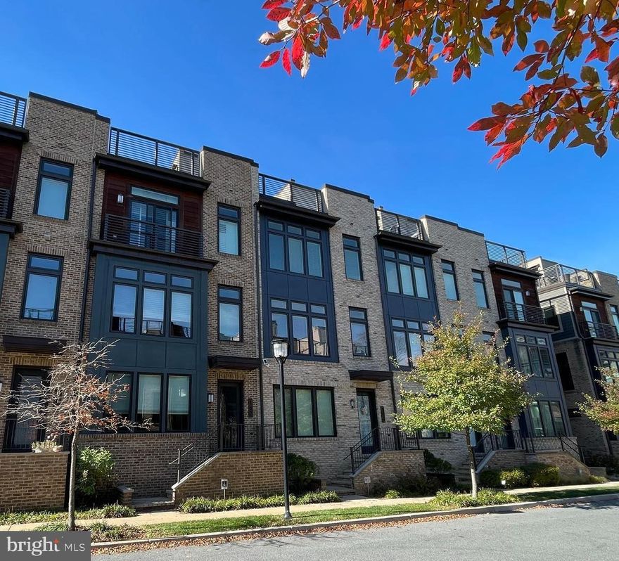 *NEW PRICE* See this gorgeous house today! Lock it and leave it living - low maintenance home in a great location! 
Just like new EYA built luxury contemporary elevator townhome situated in the ideal location in Grosvenor Heights. Meticulously maintained with designer finishes, custom touches, and inviting ambiance make this home comfortable and elegant. Enjoy tons of natural light through the floor-to-ceiling windows, complemented by top-quality custom window treatments and shutters. 3 bedrooms, 3.5 bathrooms, and an additional flexible space/office/guest area on the bedroom level!  Come see the remarkable 4th-level rooftop terrace, perfect for relaxation and entertaining, featuring a wet bar, refrigerator, stone fireplace, and a built in gas Viking Grill—an ideal setup for gatherings. Whole-house Sonos sound, TV wiring, and upgraded deck tiles. The main level offers a spectacular open floor plan with a  gourmet kitchen, custom cabinetry, Sub Zero, & Thermador appliances, and a beverage refrigerator in the spacious center island. The adjoining great room invites comfort with its fireplace surrounded by custom wall shelving, leading to a sunny and spacious deck. The ground floor suite allows for a guest or in-law suite, office,  or gym space, including a wet bar, refrigerator, and an en suite full bath. Thoughtful touches like customized walk-in closets and an upper level laundry room enhance everyday living.  In the Primary Suite, find a charming and functional window seat with storage.  The oversized 2-car garage provides added convenience and extra storage.  Fall in love with this move-in ready home with all of the conveniences for a hassle-free living experience. LOCATION! Minutes to Wildwood Shopping Center, Grosvenor Metro, Rock Creek Trail, Bethesda Trolly Trail, Fleming Park, Commutes I-270 & I-495.