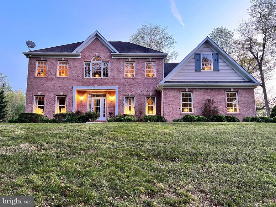Set on 6.7 acres of private, wooded land with rolling hills, fields and three streams, this executive-style colonial estate offers the perfect balance of space and comfort. The five-bedroom, five-bathroom home sits beautifully on the property, complemented by two outbuildings.