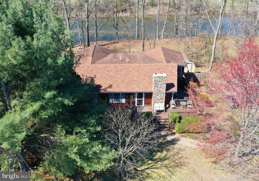 WATERFRONT HOME ON THE CACAPON RIVER. Picture perfect with 155 feet of water frontage and easy water access. Convenient to Rt. 50 and just over the state line from Virginia -  welcome home to this 3-bedroom, 2 1/2-bath rancher that is tucked away just outside the town of Capon Bridge. Equally suitable as a full-time residence or a relaxing weekend getaway. Enjoy swimming, fishing, tubing, kayaking and canoeing.  On a 1.1-acre lot that is level at the front with a circular driveway and gradually sloping from the back yard to the water. The living room and kitchen-dining areas form an 18x22 great room with a fireplace.  A pleasant sunroom overlooks the river and opens to a 16x12 screened porch with a ceiling fan, recessed lights, wood plank floors and steps to the back yard.  Bring your imagination to the unfinished walkout basement, which already is equipped with a half bath, a wood stove, and a laundry area with washer and dryer. The main level also has a washer and dryer. There are plenty of outdoor spaces to relax, cook out and entertain:  Front porch 8x26, side deck 8x22, rear patio off the basement 16x40 and a 16x12 deck right at the water's edge. Loads of storage: 20x14 garage, 18x4 shed and a 6x8 shed. There's even a 6x12 fenced dog run. On a community water system served by a well, cost is $60 per quarter.  Measurements are approximate. Sold as-is. Listing price is based on a recent professional appraisal of $356,000. Per seller, house is not in the flood zone. Fireplace is wood burning but currently has a gas log. House is a modular with additions.