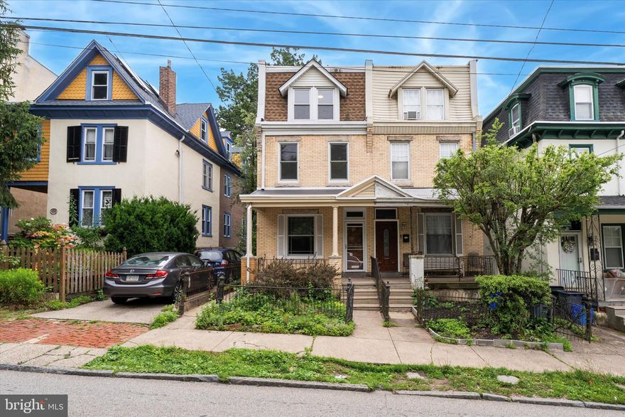 Welcome to 212 W Mount Pleasant Avenue, a timeless brick twin nestled on a wide, tree-lined street in the heart of West Mount Airy. This 5-bedroom, 1.5-bath residence offers nearly 1,800 square feet of thoughtfully preserved character, enhanced by tasteful, design-forward renovations. Located just two blocks from the vibrant shops, cafes, and galleries of cobblestoned Germantown Avenue and moments from the trails of Fairmount Park, this home is perfectly positioned to enjoy all that this cherished neighborhood offers.

The curb appeal is classic Mt. Airy — a wide front porch welcomes you with space to sit and enjoy the peaceful neighborhood or chat with passing neighbors. Inside, you'll be greeted by original hand-scraped hardwood floors, warm walnut-trimmed windows and baseboards, and a solid wood entry door with transom window. The living room features a striking reclaimed wood accent wall with custom built-in shelving and a rustic mantle over a decorative fireplace, setting the tone for the home’s warm and inviting interior.

Beyond an original walnut pocket door is the formal dining room, flanked by bay windows and open to the beautifully renovated kitchen. Designed with both function and style in mind, the kitchen features quartz countertops, a deep farmhouse sink, a custom glass tile backsplash, and rich charcoal cabinetry. Open reclaimed wood shelving and whitewashed brick accents carry the rustic-modern theme throughout. Stainless steel appliances include a gas range, dishwasher, and built-in microwave.

Just beyond the kitchen is a bright and practical mudroom with slate floors, full-size LG front-load washer and dryer, a powder room, and access to the deep, fully fenced rear yard. Garden beds, mature trees, and privacy fencing provide a rare urban oasis — ideal for entertaining, relaxing, or planting your next harvest.

Upstairs, the second floor offers three sun-filled bedrooms with original wood floors, five-panel doors, and charming period trim. The full hall bath has been updated with marble flooring and window sills, beadboard wainscoting, a custom vanity, and soaking tub. On the third floor, two additional bedrooms offer generous space, reclaimed wood detail, and potential for future expansion — including possible access to a roof deck.

The basement is clean and functional, with updated electrical and HVAC systems, exposed stone walls, and ample storage or workshop space.

Additional highlights:
Original architectural details throughout
Updated kitchen and baths
Private backyard with garden beds
Full-size laundry/mudroom with outdoor access
Convenient access to SEPTA bus routes and both Chestnut Hill East and West Regional Rail lines

Mt. Airy offers the perfect blend of urban vibrancy and leafy tranquility. Enjoy proximity to the Wissahickon trails, Weaver’s Way Co-op, High Point Café, and beloved neighborhood favorites like Töska Restaurant & Brewery and McMenamin’s Tavern. Whether you’re commuting to Center City or enjoying a weekend hike, this location offers the ideal balance of convenience, charm, and community.
Come experience the warmth and character of 212 W Mount Pleasant Avenue — your new home awaits.