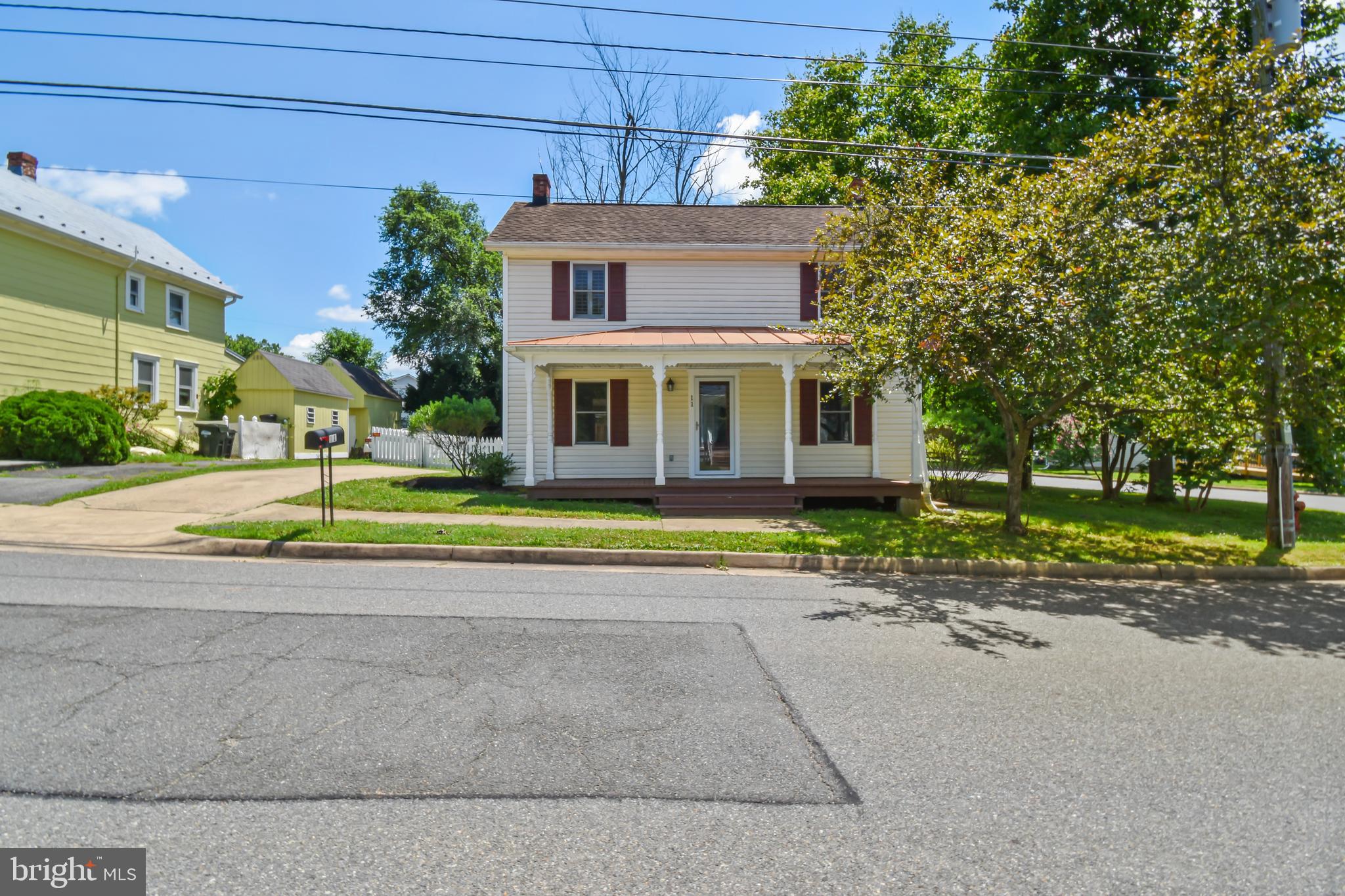 Welcome to 11 Kirche St, a charming 2-bedroom, 2-bathroom single-family home nestled in the heart of historic Lovettsville, VA. Built in 1900, this 1,260 sq. ft. treasure combines vintage allure with modern comforts on a 0.22-acre lot, offering a perfect retreat amid the serene beauty of Loudoun County. Step inside to discover warm, inviting interiors that showcase original architectural details, reflecting the home’s rich history. The thoughtfully designed floor plan features two spacious bedrooms and two updated bathrooms, blending contemporary convenience with classic character. The modernized kitchen enhances functionality while preserving the home’s timeless appeal, making it ideal for both everyday living and entertaining.
Outside, the 0.22-acre lot creates a private oasis with a fenced-in, tree-lined backyard, perfect for gardening, relaxing, or hosting gatherings. Located in downtown Lovettsville, this home places you steps from the town’s vibrant center, with local shops, restaurants, and community events like movies on the green and seasonal festivals. Just minutes from Loudoun County’s renowned wineries and scenic countryside, it also offers easy access to Leesburg, Brunswick, MD, and Charles Town, WV. Part of the welcoming Lovettsville community, this home is served by the highly regarded Loudoun County Public Schools, including Lovettsville Elementary, Harmony Middle, and Woodgrove High (verify boundaries). Perfect for anyone seeking small-town charm with urban conveniences nearby.
Ready to move in to, schedule your tour on showing time today!