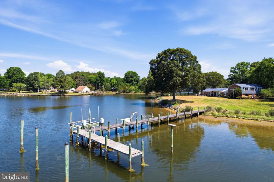 Tucked away on 1.39 private acres with approximately 530 feet of waterfront, this exceptional retreat offers sweeping water views, spectacular sunsets, and direct access just around the bend from the Potomac River. A rare opportunity for boating enthusiasts, the property features a substantial pier with multiple deep-water slips, boat lift, electric, and excellent crabbing and fishing right from your backyard.  

The spacious home offers over 4,700 square feet with 5 bedrooms and 4 full baths, including multiple main-level bedrooms and flexible living spaces designed to capture the waterfront setting. Large windows frame serene water views throughout, while expansive indoor and outdoor entertaining areas create the perfect setting for gatherings, weekend escapes, or full-time waterfront living.  

Originally built in 1974 the property includes a waterside workshop/boathouse, generous parking, and beautifully maintained grounds with mature trees and a gently sloping lawn to the water’s edge. Whether you are looking for a peaceful private residence, a weekend retreat, or the ultimate boating lifestyle, this Southern Maryland waterfront property delivers an unmatched setting