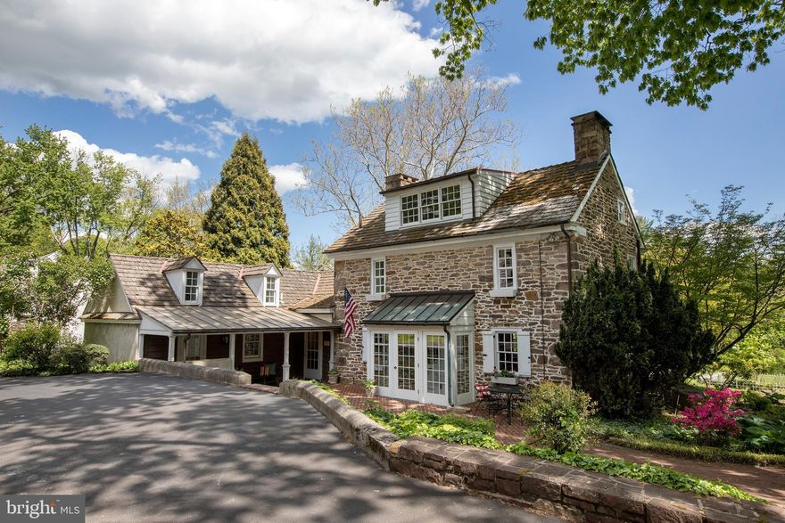 The John Fell House, circa 1733, is a one-of-a-kind Doylestown Borough property that offers a tremendous opportunity to own a piece of history on a sprawling estate-like compound.  Over two acres of park-like land and set back down a long driveway, this property was reportedly the location of George Washington's headquarters when the Continental Army camped at Doylestown in the summer of 1778.  The antique stone manor house retains all of the charm and character of classic Bucks County, without sacrificing modern amenities thanks to a 21st century full scale renovation.  Finely landscaped grounds are full of natural light in the mostly Southern-facing front yard.  An exposed stone entry hall greets you at the primary entrance on the manor house, leading to the large updated kitchen featuring a 14' cathedral ceiling, 6+2 Viking professional range with double oven, side by side SubZero fridge, and plenty of storage.  A main-level master suite was envisioned in the adjacent keeping room, with a full bathroom roughed in and ready for finishing, this space could also lend itself well to an au pair or live-in help and has a second floor loft above.  The Southern-facing sunken living room room makes a great library and has also served as the formal dining room for the home, overlooking the grounds.  The original section of the stone home retains the classic walk-in 9' fireplace complete with beehive oven and gate arm hardware.  Upstairs you will find two additional bedrooms, both nearly the length of the original home, with wide plank floors and exposed beams.  A 3 bedroom guest house is large enough to be split into an upstairs pool house and downstairs home office or guest suite, and oversized 4 car garage with workshop loft backs up to the in-ground pool.  Picture perfect down to the original stone spring house, truly a once-in-a-generation opportunity in the Borough.