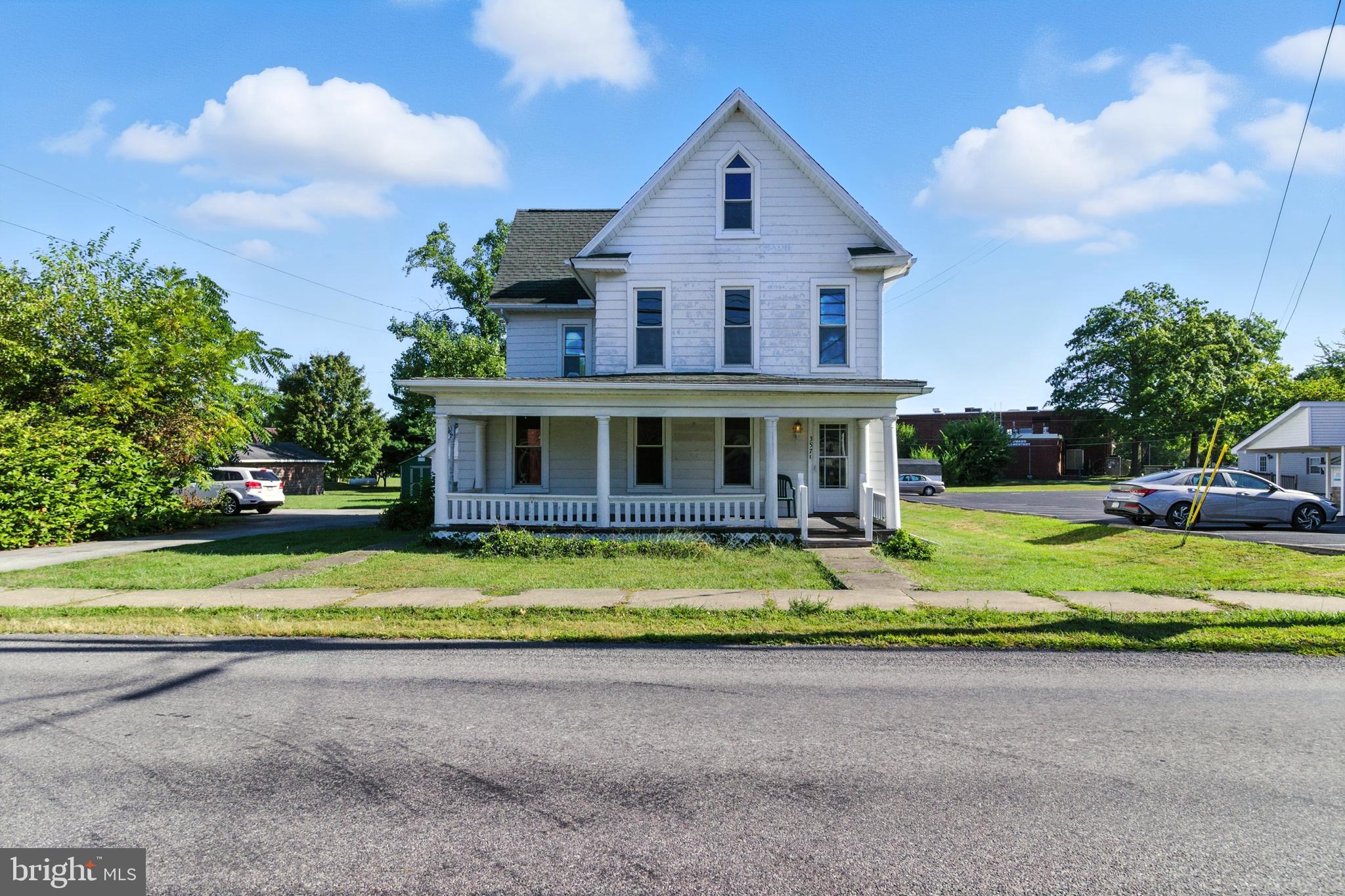 This spacious 2,500+ sq ft home with a one-bedroom apartment has tons of potential. Make this your primary home with additional income, a two-income investment property, a home with multigenerational living spaces, or simply convert it back to one large single-family home. The location is walkable to restaurants, parks, schools, and the post office.
The main house features three bedrooms and a full bath upstairs, along with large storage closets and a wide-open attic—ideal for finishing into additional living space. A generous living room with built-ins and a wood-burning fireplace, a large dining room with built-in cabinetry, and a spacious kitchen with an attached mudroom and laundry area make up the first floor.
The separate one-bedroom, one-bath apartment with its own entrance and electric service is also located on the first floor—. The home sits on a flat lot with a two-car detached garage. While some cosmetic updates and projects are needed, this property offers great space and versatility for the right buyer.