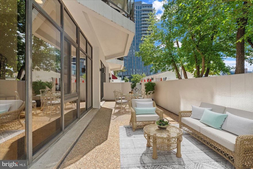 Stunning large 1 BD/ 1BA move-in ready condo in the heart of Rosslyn. Enjoy the gorgeous rooms with soaring ceilings, hardwood floors, open floor plan and light that pours in from the sliding doors and floor-to-ceiling windows. This particular unit has an ideal location in the Atrium building with a large ground level patio that faces the gated pool and barbecue area and is steps away from the "residents’ only" dog park. There are custom vertical sheer blinds in the living room and top down/top up block out cellular blinds in the bedroom but no need to worry about privacy from passing pedestrians - this  unit does not face the street or sidewalks. Instead it faces the Atrium’s common outdoor areas that are gated and quite private. The kitchen has ample cabinets, granite counter tops, stainless steel appliances, pantry shelving, and overhead lighting.  The bathroom was retiled in 2022 with a fresh updated look.  The in-unit washer and dryer in entry closet.  You’ll love the primary and hall closets that have Elfa Shelving. There is plenty of storage with 2 additional closets and a storage space that is conveniently located on the lobby level, about 150 ft from the condo. The reserved garage parking spot also conveys. Pets allowed within size restrictions.  Located in the heart of Rosslyn, the Atrium Condominium is located on a quiet side street, and is walkable to Metro, shops, restaurants, walking/bike paths and Georgetown. Arlington County Schools. Easy access to Rte. 66, GW Parkway and close to Reagan National Airport. Condo fees include water, trash, Fios TV preferred HD and Fios Internet 300/300, 1 assigned parking space, pool, gym, tennis court, dog park, 24 hour front desk security.