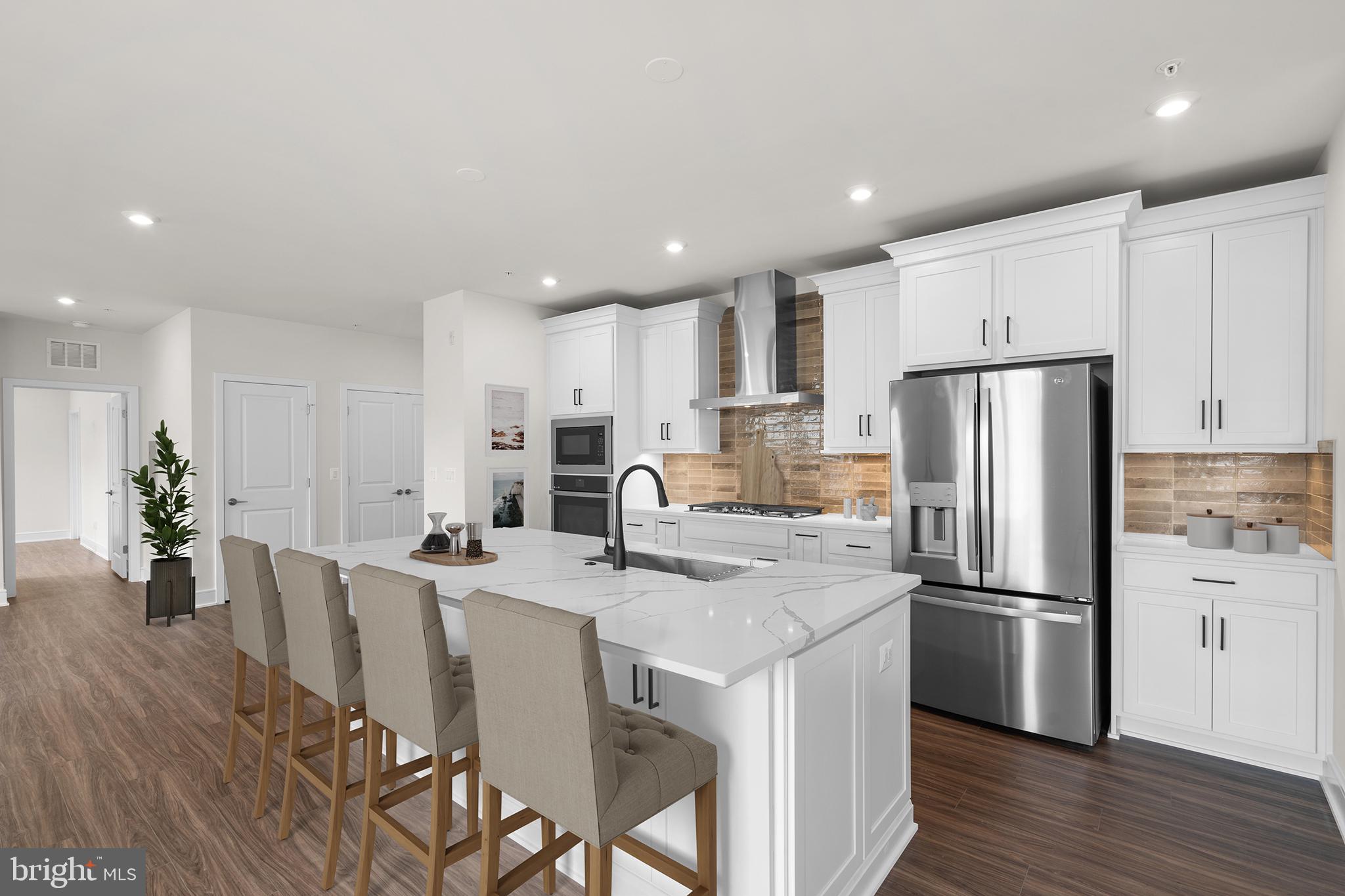 Don’t miss your chance to own the home of your dreams in an incredible community! This brand new ACTIVE ADULT (55+) CONDOMINIUM is ready to move in IMMEDIATELY. The NEWMAN III floorplan by Van Metre Homes at BIRCHWOOD provides luxury living at its finest! This stunning condominium boasts 1,419 finished square feet of masterfully crafted space all on one level with lofty 9' ceilings. As you enter, be greeted by the warmth of natural light and sparkle from luxury vinyl plank flooring, connecting and highlighting the stylish open floor plan of this spacious abode. Relish in the home’s large great room, comfortable dining room, and a showpiece premier kitchen, where upgraded cabinets, quartz countertops, tile backsplash, and stainless-steel appliances elevate the culinary experience. Need some fresh air? Step onto your personal balcony to prepare for the day ahead or unwind from its adventures. Your private oasis awaits in the impressive primary suite, complete with two generous walk-in closets and a luxurious 4-piece bathroom featuring double sinks and a large, frameless shower enclosure with a built-in seat – the epitome of relaxation and comfort. This impeccable condo offers an additional bedroom and full bathroom to accommodate your needs and lifestyle. Additionally, this residence includes a 1-car garage with electric car charging capabilities, providing both security and convenience for your vehicle. Being a new build, your home is constructed to the highest energy efficiency standards, comes with a post-settlement warranty, and has never been lived in before! Discover the unmatched luxury awaiting you! Schedule your appointment today! ----- Located in Northern Virginia, Birchwood at Brambleton is an Active Adult (55+) community that offers one-level condominiums and spacious single-family homes. Residents benefit from its close proximity to Brambleton’s restaurants, shopping, movies, and community events. The community boasts top-notch award-winning amenities like indoor and outdoor pools, bocce and pickleball courts, a fishing pond, and a golf simulator. Additionally, Birchwood at Brambleton’s convenient location places it just minutes away from Metro’s Silver Line, Dulles International Airport, commuter routes, and health centers, making it a prime destination for those seeking a well-connected and vibrant lifestyle. ----- Take advantage of closing cost assistance by choosing Intercoastal Mortgage and Walker Title. ----- Other homes sites and delivery dates may be available. ----- Pricing, incentives, and homesite availability are subject to change. Photos are used for illustrative purposes only. The community lies within the Airport Impact Overlay District (within the 1 Mile Buffer). Due to its proximity to Dulles International Airport, this site is subject to aircraft overflights and aircraft noise. For details, please consult the Community Experience Team.