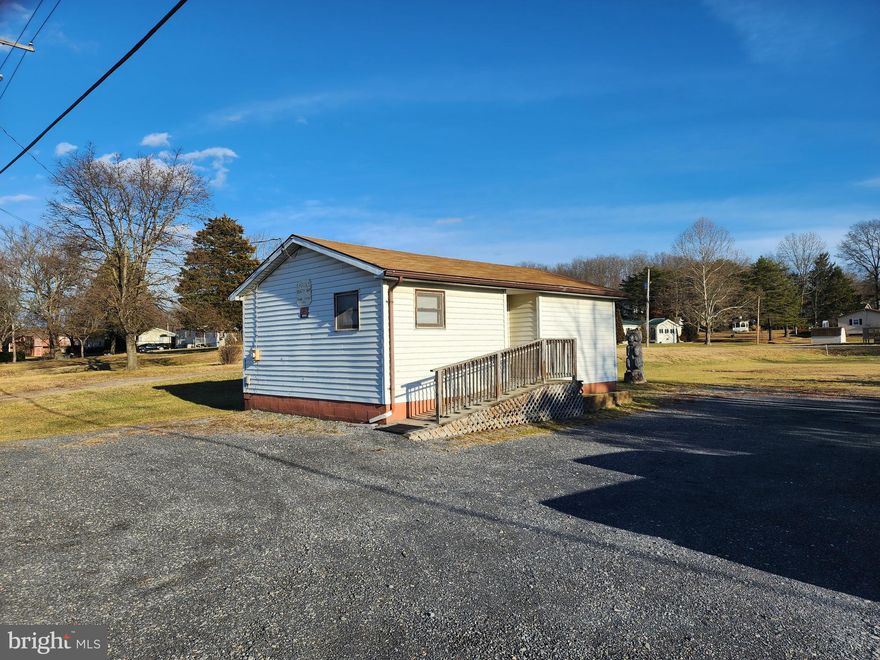 INVESTOR ALERT!  FORMER BEAUTY SALON AND MOBILE HOME SITE LOCATED IN THE QUIET COUNTRY TOWN OF FT. ASHBY.  THIS PROPERTY OFFERS MANY POSSIBLE OPPORTUNITIES FOR INCOME GENERATION.  CONTINUE TO USE IT AS A BEAUTY SALON OR BARBER SHOP WITH FIXTURES STILL IN PLACE.  ADD A SHOWER AND KITCHEN TO CONVERT IT INTO AN EFFICIENCY APARTMENT.  PULL A SINGLE WIDE ONTO THE EXISTING PAD WITH ALL UTILITY HOOKUPS IN PLACE.  PUBLIC WATER AND SEWER AND PLENTY OF ROAD FRONTAGE.  LET YOUR IMAGINATION DEVELOP THIS PROPERTY INTO ITS FUTURE USE.  CALL TODAY!