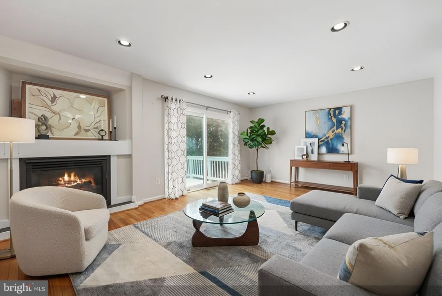 Nestled in a quiet community within walking distance to Reston Town Center, this elegant brick front townhome offers 4 bedrooms and 3.5 baths plus a one-car attached garage.    Enter from the garage or front door into a roomy ground floor foyer with gleaming hardwood flooring.  The ground level 4th bedroom or study/den has a full bath and patio doors onto the rear lower deck.  Upstairs on the main living floor you'll find immaculate hardwood floors throughout (also on both staircases), plus an attractive gas fireplace and mantle in the generously sized living room , including patio doors leading out onto the upper deck.  The eat-in kitchen boasts granite counters, stainless steel appliances, plus floor to ceiling windows with beautiful white plantation shutters.  The formal dining room is dramatically raised between the kitchen and family room, making it a convenient entertaining area.
A half bath with an elegant pedestal sink is conveniently located on the main floor.
On the upper bedroom level you'll enjoy the primary suite featuring a dramatic vaulted ceiling, walk-in closet, and luxury full bath with oversized walk-in frameless shower with dual shower heads, granite counter top vanity and heated tile floors.  Two secondary bedrooms share a hall bath also with granite counters.  Dramatic 9 ft ceilings throughout.
Located only steps away from the community pool and club house.  You won't want to miss this opportunity to call this lovely townhouse home!
Recent upgrades: New carpet installed on entire upper bedroom level (2026),  living room hardwood floor refinished and walls painted (2/2026)  -  Roof (2019) -  HVAC (2019)  -  Hot Water Heater (2019) -  Windows replaced (2011)