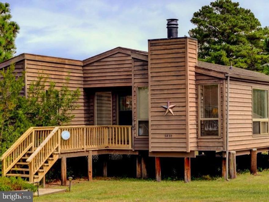 CHINCOTEAGUE WATERFRONT LISTING! Terrific bay views from this lovely 2BR 2BA home on an oversized corner lot in Richardsons Landing! *BONUS ROOM* plus large screened porch looking right up the canal for awesome bay views! Comes with "most" furniture, too. Total "cottage feel" and cute as a button... with real woodburning fireplace and new wood flooring, outdoor shower, fenced yard and boats and kayaks come with the house! 1st floor bedroom with en-suite as well. View the bay and hear the water lapping from your bed and you won't want to get up mornings!