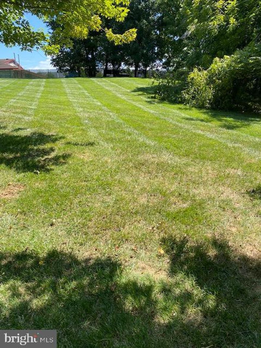 Lot on left as you drive down Homeland, see disclosures for Plat.  Buyer should verify with Carroll County for available water and sewer and permits.