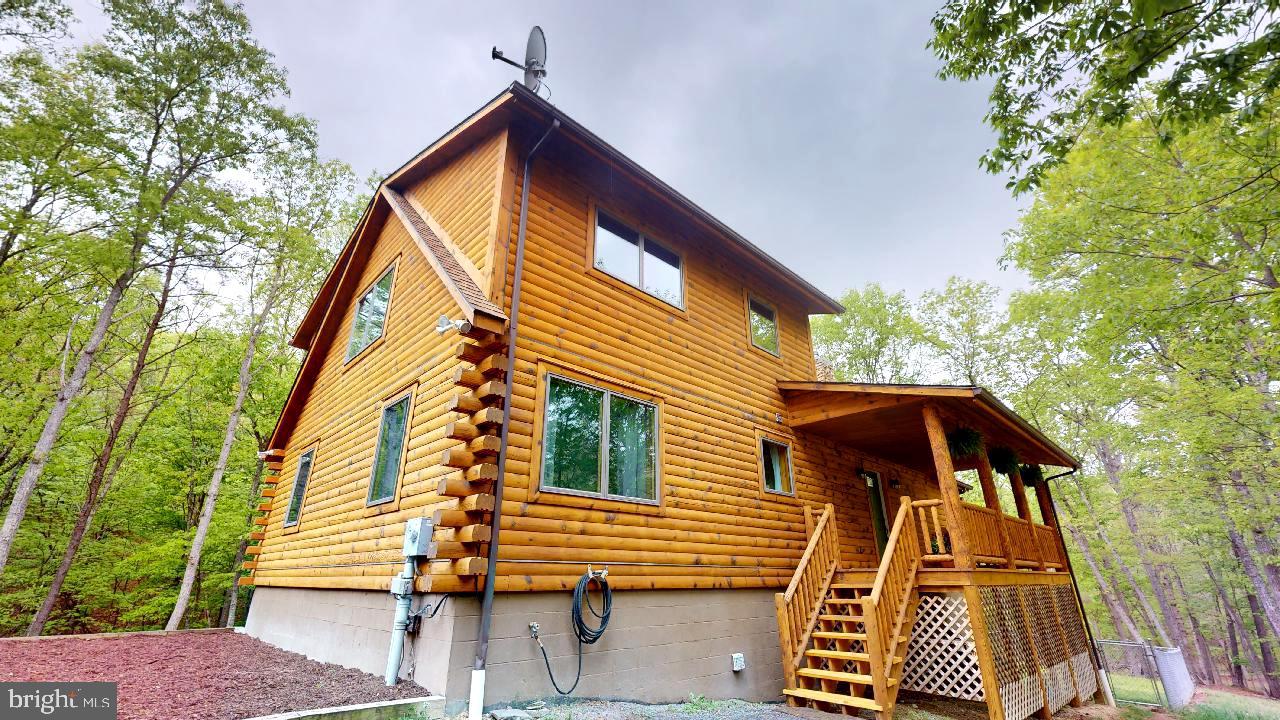 Stunning, immaculate, beautiful are just some of the words to describe this gorgeous 3-bedroom, 3-bath log home situated on just a little over 7 usable acres, in the highly desirable Taylor Lake Subdivision. Are you looking for peace and quiet, space for the kids to play, and a secluded piece of property just a short drive from town? Look no further, this one's for you! This property captivates you with over 2,300 sqft. of living space upstairs and a fully finished basement! Equip with a new water filtration system, hot water tank, and a newer HVAC system, this move in ready home has those big-ticket items already done for you! The fenced in yard allows the animals to play without worry and there are some perks for the kids too! A zipline and treehouse? Sounds perfect to me, ask your kids I'm sure they'd agree! On those hot summer days head down to the private community lake to enjoy a sunny day on the water. Then during the fall and winter months enjoy the wood burning fireplace or roast marshmallows by the outdoor firepit. On a brisk cold morning sit on the porch overlooking wooded acreage and listen to the nature that surrounds you! Properties like this aren’t available too often, and this rare gem is the perfect slice of almost heaven West Virginia! Don't sleep on this one, schedule your appointment today!