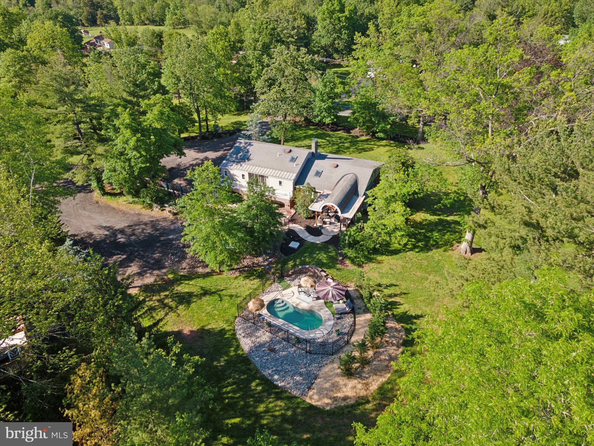 SEIZE THIS CHANCE to own a spacious 4-bedroom, 3-bathroom split-level retreat on just under 2 Acres in the desirable Methacton School district. If you want to entertain guests or relax in a peaceful surrounding, this property has something for everyone! Enter in from the large front porch overlooking the lush green outside space to find a semi-open floor plan. The formal living room and dining room are ideal for hosting special occasions. The spacious kitchen has been updated with lots of storage, a large pantry, quartz countertops, and island seating perfect for casual meals and meal preparation. Upstairs, the light and airy main bedroom with en-suite bathroom and walk-in closet are a delightful addition to this sanctuary. Yet the true treasure of this bedroom is the sliding glass doors that open to a private patio, where you can stand or sit as King or Queen and look over your expansive and serene backyard. There are three more ample-sized bedrooms, a bathroom and laundry area to finish off this floor. Downstairs you will find a large family room with a full bathroom and Mudroom. There is also a basement complete with shelving for extra storage. Attached is an oversized 1-car garage. Stay cool or warm with the recently added ductless AC system with 5 year transferable warranty. If you thought the house was amazing just wait for the outside! Just off the kitchen is a covered patio area with enough space for a barbecue grill, patio furniture, and even a fire pit. Right off the patio you can enter the gated area and soak up the direct sunlight or jump in the heated pool for a swim. There is a secondary patio area to set up more seating to look over the large pond perfect for adding fish or just enjoying the tranquil water view. There is even a dedicated area for gardening. Do you need extra parking space? There is not just one, but two, carports that are the perfect height for a boat and RV. The detached garage with parking for two vehicles has a covered pad where a third vehicle could be parked. Above the garage, which the owner refers to as “The Club House,” is a bonus space that could be used as office space, craft area, man cave, or even playroom. The club house also boasts a massive deck that overlooks your outdoor oasis. And just when you thought we were done…there is an outdoor Wood burner, that supplies warmth to the main house for those cold winter months. This versatile property offers incredible potential for homeowners, entertainers, and those needing extra space for vehicles and hobbies. This property has it all. DON’T MISS THIS OPPORTUNITY TO MAKE IT YOURS! MOTIVATED SELLERS!