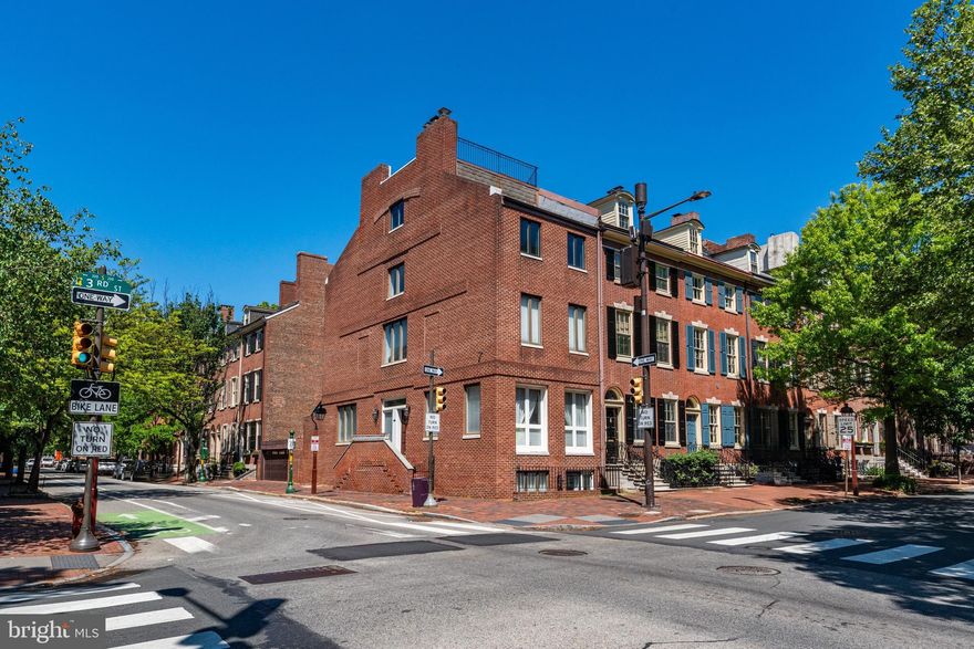 Welcome to 303 Spruce Street, a grand four bedroom, four and a half bath residence with rare secure two-car off-street parking and a separate two bedroom, one bath apartment. Ideally located on a large corner lot in the true heart of Society Hill, this exceptional home blends historic Philadelphia character with a contemporary feel and highly functional living throughout.

The main level welcomes you with soaring ceilings, an open layout, and abundant southern exposure. The expansive sun-drenched living room is centered by a gas fireplace, creating a warm yet modern gathering space that flows effortlessly into the dining and entertaining area. The gourmet kitchen features Viking appliances, granite countertops, a seated island, and a bright breakfast nook. A convenient powder room completes this level, along with access to the private two-car parking.

The second floor is dedicated to a luxurious primary suite, featuring a spacious bedroom with a wood-burning fireplace, a walk-in closet, and an oversized spa-like bath complete with double sinks, a stall shower, a sauna, and a Jacuzzi tub.

The third level offers two generously sized bedrooms, each with an en-suite bathroom. The top level provides incredible flexibility as a fourth bedroom, office, gym, or den, and it also includes its own bath. This level also includes a large laundry room, additional storage, and access to the roof deck.

From the rooftop, take in sweeping city views. You will have the pleasure of watching fireworks on the 4th of July and New Year’s Eve, a truly spectacular experience.

A unique quality of this home is the private entrance to its two-bedroom, one-bath apartment with a den. This space is ideal for guests, extended family, or another source of income.

Additional highlights include hardwood floors throughout, central air, and a layout that maximizes both flow and livability at every level.
Located just steps from some of Philadelphia’s most renowned restaurants, Head House Square, Washington Square, Spruce Street Harbor Park, Penn’s Landing, as well as many famous historical sites.

This home offers unparalleled walkability. With easy access to I-95 and Philadelphia International Airport, convenience meets lifestyle in one of the city’s most iconic neighborhoods. This is an incredibly rare opportunity to own a spacious, versatile, and beautifully located home in Society Hill.