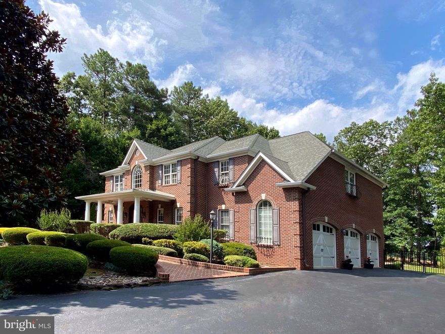 Impressive  Custom Dream Home with private pool in the luxury gated lake and golf community of Fawn Lake. Expertly curated with superior craftsmanship, timeless architectural elements and incredible attention to detail at every turn. Exuding curb appeal, the stunning brick Facade with wrought iron balconies and a handsome brick sidewalk, leads to a gorgeous front porch. 
The well appointed interior offers stunning luxury details such as coffered ceilings, palladium windows, archways, rich moldings, and solid wood floors. The grand two story foyer with marble floors and a beautiful staircase with solid wrought iron spindles set the stage from the moment you step through the double mahogany doors. An elegant Dining Room with exquisite details, rich millwork and arched windows provides a perfect backdrop for formal gatherings.  A formal Living Room with a coffered ceiling  flanks the entryway.
A spectacular two-story Family Room with a soaring stacked stone Fireplace and Built-in media cabinets, features a wall of windows overlooking the incredible backyard oasis. The Gourmet Kitchen offers stainless steel appliances, center Island, walk-in pantry, a sunny Breakfast area, and access to the rear patio and the beautiful saltwater swimming pool. 
A second staircase leads to the upper level, which features a Spacious Owner's Suite with luxurious Spa Bath and a fabulous walk-in closet. Two Gracious Bedrooms sharing a Full Bath with dual vanities, plus a fourth bedroom with a private full bath. 
Designed for entertaining, the finished Basement features an Amazing home Theater with leather recliners and a massive screen, perfect for watching your favorite movies and shows!  A Recreation Room with gas fireplace , Full Bath, and a versatile space with a huge walk-in closet, currently utilized as a Hobby Room, can function as a  gym or home office.  
Immersed in privacy, the fenced backyard is surrounded by mature hardwoods enhancing the idyllic outdoor sanctuary.  Built in 2023,  the beautiful heated swimming pool is the main attraction of the backyard oasis. The expansive pool deck provides ample space for lounging and relaxing poolside! Blending seamlessly with the landscape, the large patio maximizes outdoor living, and offers plenty of space for alfresco dining and entertaining. Beautifully landscaped grounds with manicured shrubs and large Magnolia trees highlight the exterior of the property. The oversized 3 Car Garage with beautiful Carriage doors features tons of cabinets for staying organized. An extended driveway provides ample parking. Recent updates include: newer stainless steel kitchen appliances. The  HVAC systems were replaced in 2017. 
***The beautiful Luxury Fawn Lake Community offers amazing amenities such as a boating recreational lake, beach, Arnold Palmer designed golf course, tennis courts, baseball and soccer fields, dog park, volleyball courts, walking trails, Community Club House, marina, fitness center, restaurants, Country Club, playgrounds, and so much more! Located on the countryside near the town of Fredericksburg, surrounded by park lands and only a few miles to the farm market, wineries, and award wining breweries!