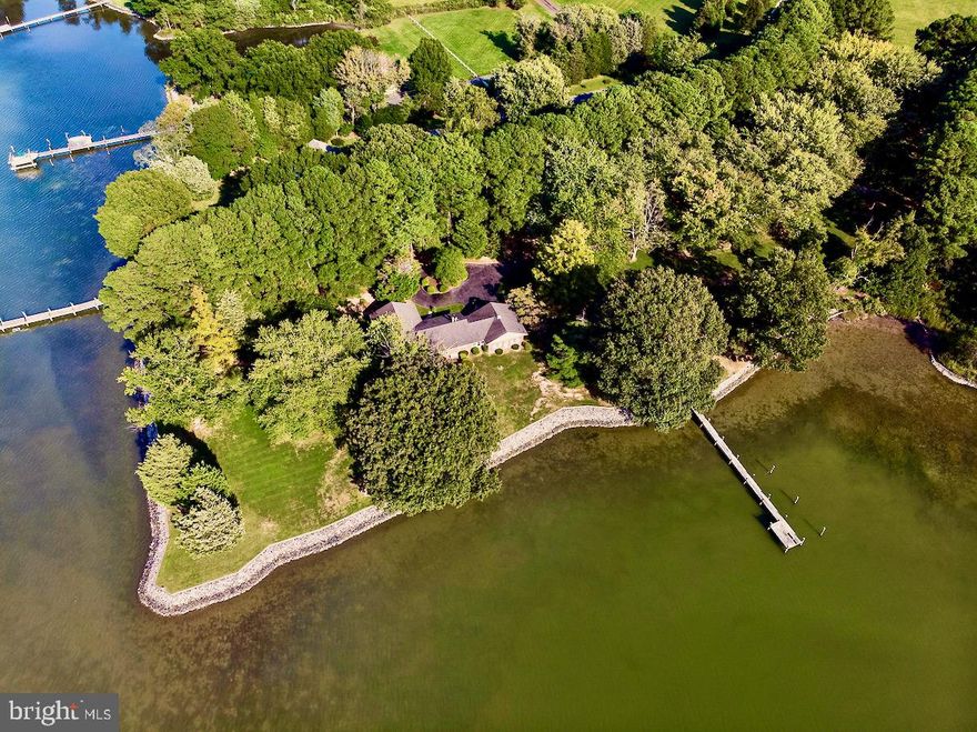 First time offered for sale in almost 60 years, this magnificent,  3.4 Acre, "Point of Land", with 660'+/-  of beautifully rip-rapped shoreline, 120' Pier with Boat Slip, 4' MLW and breathtaking panoramic views of Broad Creek. Meticulous landscaping with a variety of stately, tall ancestral trees. This wonderful point lot includes an all Brick Rancher/Rambler with 3 bedrooms, 2-1/2 Baths. Family Room with Brick Wood burning Fireplace and Mantel and Built-Ins on each side. Mostly Hardwood floors throughout.  Enclosed breezeway with water views and an attached 2 Car Garage with work area.  A paved tree lined driveway with brick entry pillars. It is located just a few short minutes from the heart of downtown St. Michaels and all of its amenities.  Come and relax with the sunsets, summer breezes, change of seasons and boating from your private dock and cruise throughout the bay and  enjoy the wildlife and peacefulness it offers.
