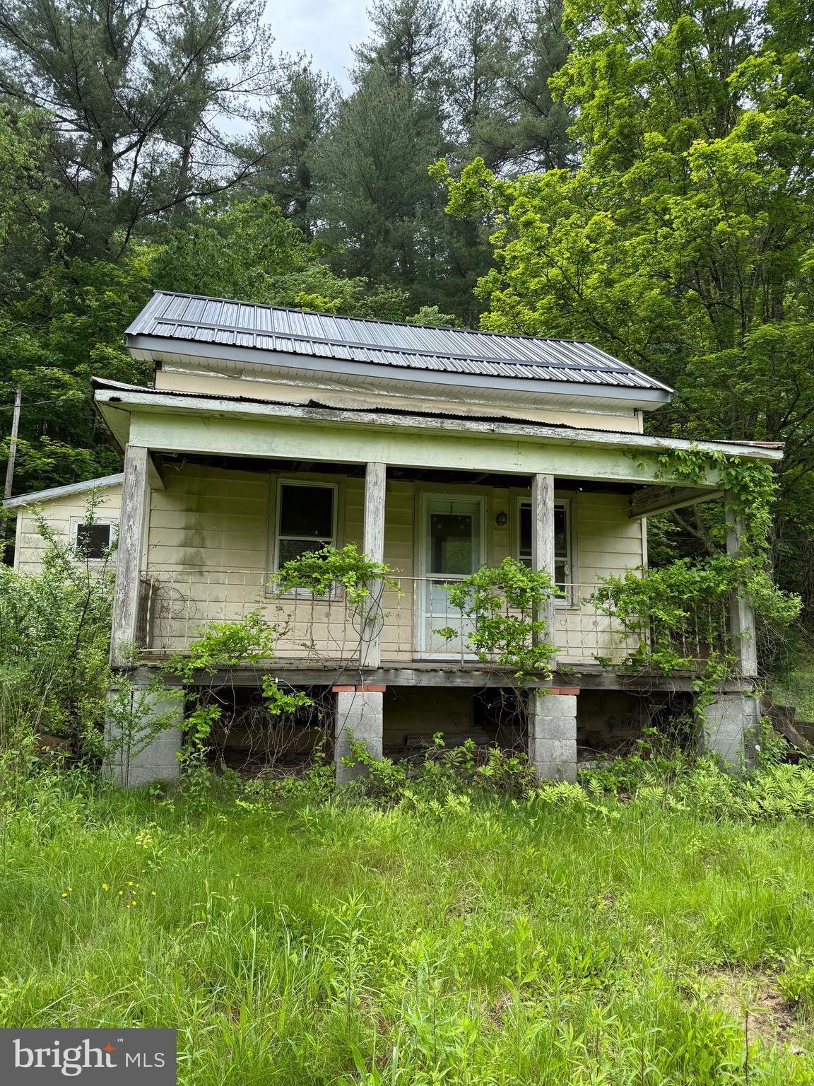 Welcome to 22015 Waterfall Road, a cabin/primary residence nestled in the tranquil borough of Three Springs, Pennsylvania. Huntingdon County boasts a plethora of attractions, including Lake Raystown Resort, Downtown Huntingdon, museums, and a rich historical heritage. Situated within the 4A Hunting zone, adjacent to Game Lands No.121, this property is ideal for those seeking a getaway cabin or a secluded primary residence. The interior has undergone a complete gut, with water and sewer lines capped in the basement/electricity cut at the pole. The property now features a new metal roof, subfloor, floor joists, and rafters. With a sturdy structure complementing the property an oversized two-car garage on a five-acre lot. This space includes ample parking, a wooded area, and a hilltop area. The property holds untapped potential and awaits your vision. Upon request, Sellers will offer lawn mowing services to enhance the property’s curb appeal. Schedule your viewing today and make this property yours.
