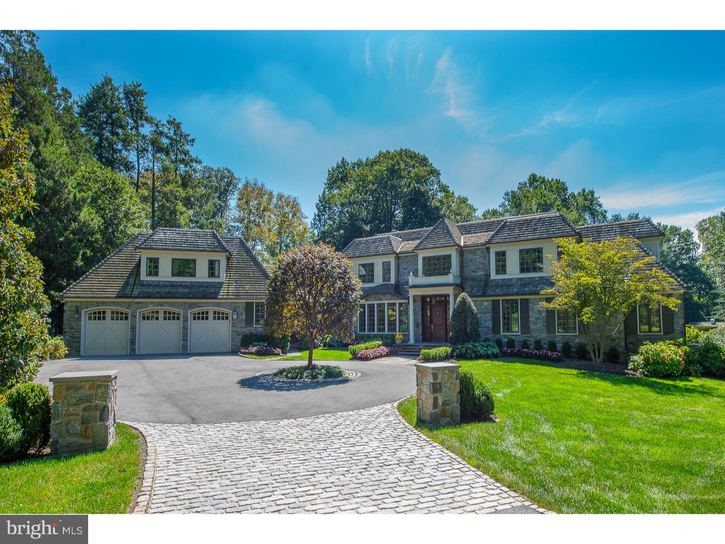 Located on this premier Main Line Road, you'll find a beautiful 1.62-acre property in absolutely move-in condition. There are no improvements left to do here; it's been updated and improved by its present owner with style and sophistication combined with ease and comfortable living spaces. The detailed architecture includes beautiful wide-planked hardwood floors, high-end solid wood doors, custom cabinetry, and an open staircase. Upon arriving at the Belgian block driveway entry, you approach the elegant circular, beautifully planted island. The entry is bright and inviting with alcoves to display your artwork. The step-down living room with fireplace has French doors leading to the rear grounds. A study off the foyer has a wall of rich walnut cabinetry. The gourmet kitchen is equipped with two dishwashers, both a wall oven and range oven, a large center island with counter seating, and new Sub-Zero refrigerator. Off the kitchen is the butler's pantry with refrigerator for wine and food. Adding to the abundance of cabinetry, even the mud room has custom storage and counter space. The family room adjoining the kitchen has custom-built cabinets which house the TV, shelving, and wet bar behind doors. Down the gallery hall is the master bedroom. Here you'll find a large room with a wall of windows with access to the grounds. The master bath has separate vanities, a large shower, and a separate infinity bathtub. The oversized walk-in closet is outfitted with drawers providing ample room for everything. The dazzling 2nd floor has four large bedrooms with walk-in closets. Two bedrooms are ensuite along with three baths. In addition to the bedrooms, a large, wonderful, whimsical room plus a billiards room are on the 2nd floor. Your guest accommodations are also met in the home. Privately located is a spacious bedroom with bath and two large closets. If entertaining is what you desire, the outdoor contains a swimming pool with slate decking and a covered lounging area for eating and relaxation. Here is the opportunity to live on this prestigious, quiet road with easy access to the train, major highways, and Center City Philadelphia.