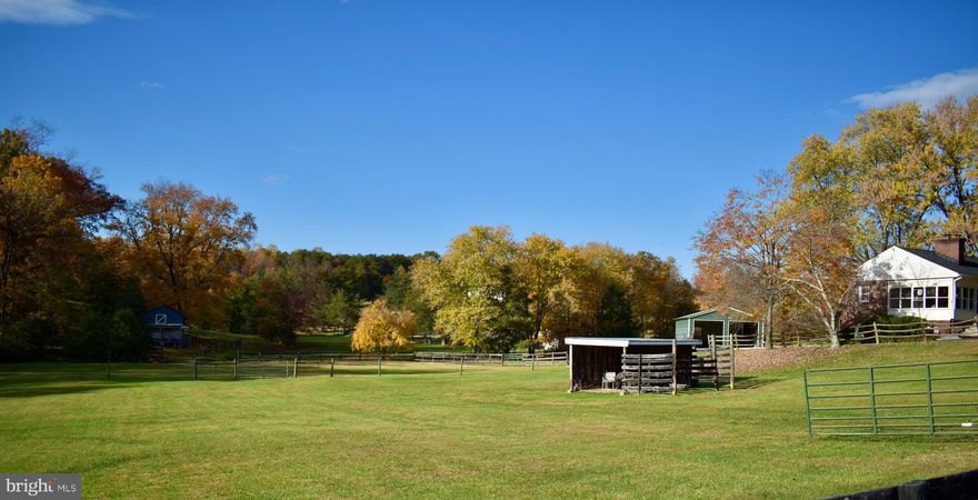 MOTIVATED SELLERS!!!!  Welcome Home to this adorable well maintained brick rambler situated on 10 Acres.  Four Bedrooms 2 full baths. Original hardwoods floors in living room, front entry, hallway, and two bedrooms. Main level  bathroom was updated two years ago and has a stand up shower. There is high speed internet with hook ups in most rooms. Full finished basement. Property is fenced with two streams. There is a three stall barn with hay loft. Outbuilding and detached garage both have electric.