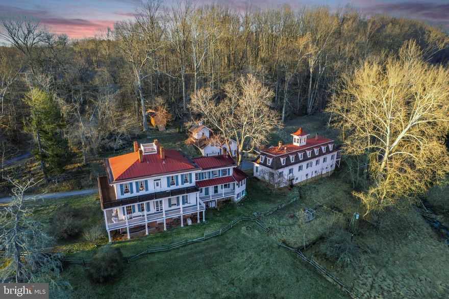 Perched gracefully amidst the rolling hills and storied landscapes of historic Glencoe, Glencoe House is an architectural jewel, steeped in the rich heritage of early 20th-century Maryland. Built in the mid 1850's and developed as a summer resort, this extraordinary residence exemplifies timeless craftsmanship and enduring design. Capped with its signature red metal roofs, Glencoe House rises with a quiet grandeur over panoramic vistas of the Gunpowder River valley. With its commanding presence and refined proportions, the home invites a lifestyle immersed in beauty and nature. Every season is a celebration here—from bucolic strolls through the countryside to invigorating cross-country skiing along the nearby NCR Trail. The main residence boasts soaring ceilings, irreplaceable period mantels, and a sweeping stair that anchors the home with stately grace. The majestic dining room, fit for elaborate feasts and spirited gatherings, opens seamlessly into generous entertaining spaces, offering the rare ability to host both intimate soirées and grand galas. Wraparound porches encircle the home, beckoning quiet moments and long afternoons spent with breezes and breathtaking views. A substantial Carriage House... reimagined.  The lower level of the main house reveals exposed stone walls—an atmospheric and evocative setting, ideal for a wine cellar, speakeasy lounge, or home theater. Recognized on the Baltimore Landmarks list, the Glencoe estate stands as a living legacy... an unparalleled canvas upon which to create a generational retreat. Hereford Zone... minutes to The Milton Inn and Hunt Valley Town Center and steps to the NCR Trail. Xfinity Internet. Cultivate your existence. The art of uniting human and home.