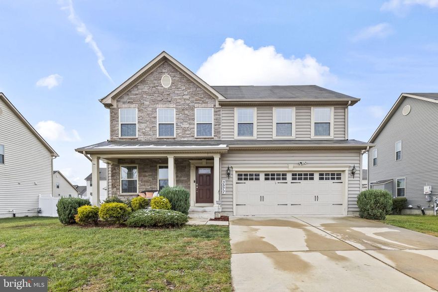 Welcome to  a beautiful stone-front Colonial with a cozy covered porch, a front-entry two-car garage, and a lovely deck overlooking a level, fenced backyard. Freshly painted interior and new carpeting means you can move right in.  Enjoy a formal living room and a stunning island kitchen featuring stainless steel appliances, granite countertops, a cooktop with double wall oven, built-in microwave, dishwasher, and a designer glass tile backsplash, all set on rich hardwood floors. The kitchen opens to a spacious family room with a floor-to-ceiling stone gas fireplace and ceiling fan, while a sliding glass door from the breakfast nook leads to the deck for easy outdoor relaxation. The upper level offers 4 comfortable bedrooms, including an owner’s suite with tray ceiling, large walk-in closet, and a luxurious bath with double vanity, step-in shower, and oversized jetted soaking tub, plus a convenient laundry room. The recently finished basement adds even more space with a large recreation room, a stylish full bath, and a versatile media/gym/5th bedroom. Solar panels are leased and will convey, making this home both inviting and energy-friendly.