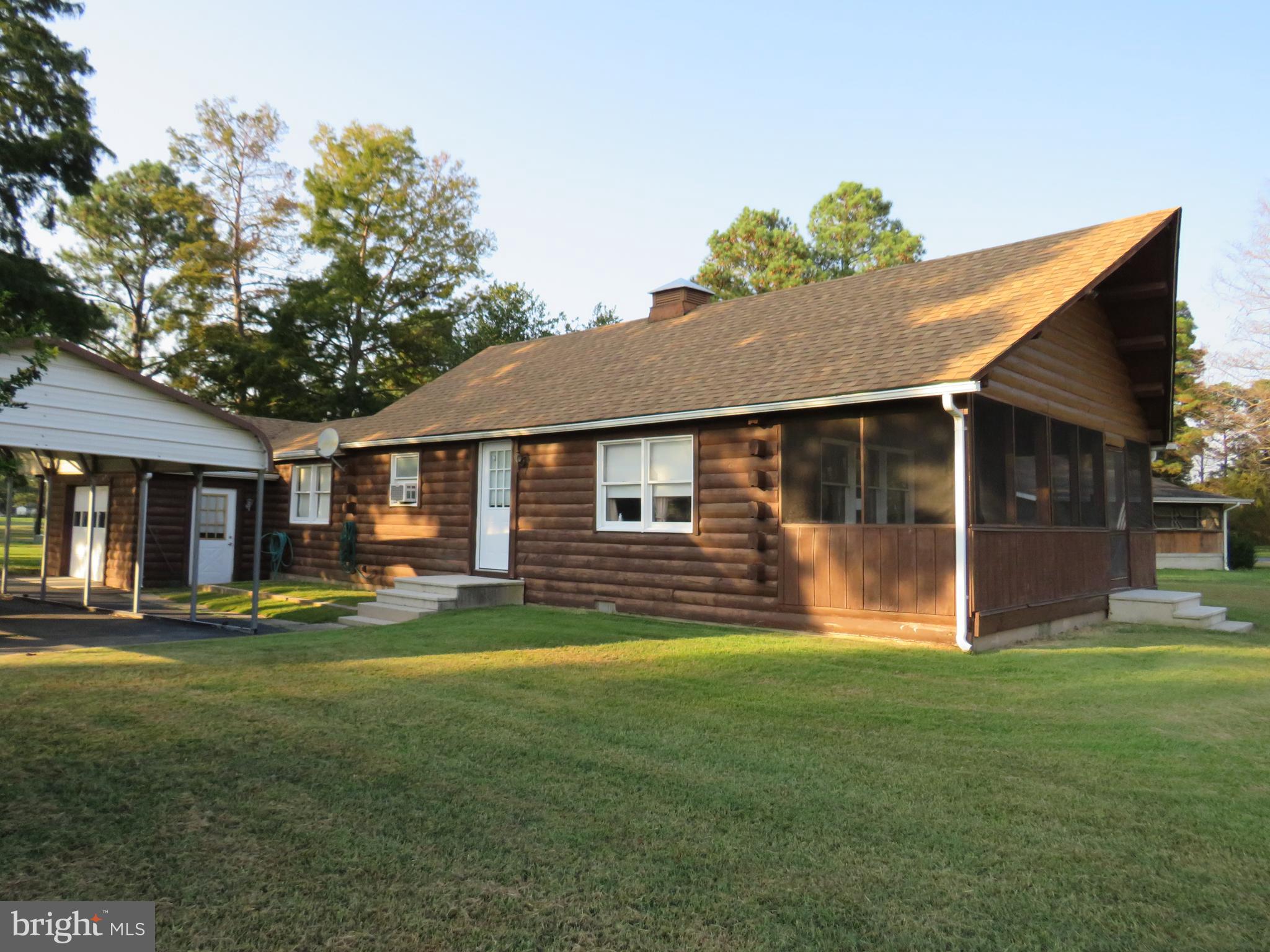 Waterfront log cabin has so many charming features, open floor plan with vaulted ceiling in great room, solid log construction, log siding on garage and utility room. Architectural shingled roof is only 4 years old. One bedroom on first floor, office and utility room. Large 9'x 20' porch overlooking the canal and Jones Creek. Bedroom on second floor with small loft area. Utility room has stack washer and dryer. New mini split ductless HVAC system just installed. Bathroom recently updated. Complete slab under crawl space. Large oversized single car garage with work bench, with separate half bath located inside the garage. Need more space? Garage could easily be converted to additional living space. There is a freestanding carport that was boat storage for the previous owner, and a 10'x12' storage shed. Permits in place for dock against bulkhead. Community has their own private launching ramp at the end of the canal. Sit on the large rear porch overlooking the canal and eat steamed crabs! Just minutes from prime fishing area and Janes Island State Park beaches.