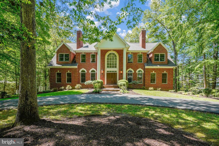 This timeless, all-brick colonial sits on 1.72 private acres with a welcoming elegant semi-circular drive. Spanning 6,600 square feet across three finished levels, the home features an open-concept layout with 9-foot ceilings and expansive windows that flood the home with natural light.
The main level is designed for modern living, boasting of hardwood floors throughout the dining area, family room, and the gourmet kitchen. The kitchen is equipped with granite countertops, a center island with a hood, a gas cooktop, and a Sub-Zero refrigerator. This floor also includes a private office and a highly coveted FIRST FLOOR BEDROOM  AND a full bath.
Upstairs, the grand owner’s suite serves as a true retreat. The primary bedroom showcases a tray ceiling, a cozy fireplace-lit sitting room, spacious walk-in closets, and three additional bedrooms.  The lower level is a bright, walk-out lower level that is a home unto itself.  Featuring a full kitchen, two full bathrooms, two additional rooms, and a laundry room with two washers and dryers. Outside, the property is a haven for relaxation and entertaining, offering a large deck that overlooks the expansive backyard and a patio centered around a fire pit. Additionally the home has a sprinkler system, a generator and EV charger installed.Deck composite railing are to be installed in May.