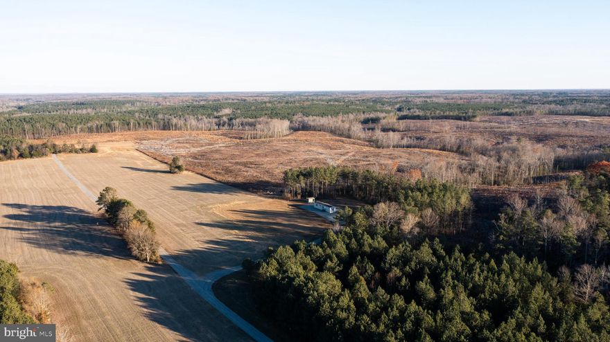 Nestled in a prime location between Fredericksburg and Richmond, this incredible property is just over 5 miles from I-95, yet it offers unmatched privacy and serenity. Situated more than half a mile off the paved road, the property is accessed via a mile-long, 5-inch packed gravel road, with the northern property line centered along the drive. This secluded haven is perfect for hunting and recreation, featuring a shooting range with targets out to 300 yards and abundant wildlife, including whitetail deer, turkey, bear, bobcats, and coyotes.

For outdoor enthusiasts and those seeking versatility, the property includes a Kioti NX 6010 tractor with a climate-controlled cab, along with a complete set of implements: a grapple, bush hog, tiller, grader scraper, loader forks, and a bucket. Complementing the land’s recreational appeal is an impressive 30x50 metal garage, built in 2016, conveniently situated nearly a mile back off the road on a blacktop pad. Heated by a wood-burning stove, the garage offers year-round utility. Additionally, a farming lease is in place for the 11+/- acres of tillable land located on the property, enhancing its usability and income potential.

Ideal for a hunting camp or rental home, the property features a 64x14 trailer (installed in 2016) with 2 bedrooms, 2 bathrooms, and propane heat (tanks owned by the seller and filled by E.M. Gray & Son). Situated on a 3-acre parcel within the main tract, the trailer is sold as-is, with any inspections or studies conducted by the buyer for informational purposes only. Practical utilities include underground power through REC, a 60-foot-deep well, and a 4-bedroom conventional septic system. Adding to its potential, there is another perc site located and marked on one of the most scenic parts of the property, making it perfect for future development.

The 30-foot-wide right of way is accessed by only three other parties, offering great exclusivity. Whether you’re looking to hunt, farm, or create a private retreat, this unique offering delivers it all. Don't miss your chance to own this extraordinary slice of tranquility—schedule your showing today! An adjoining 28.9-acre parcel is also available, providing additional opportunities for expansion—contact the listing agent for details.