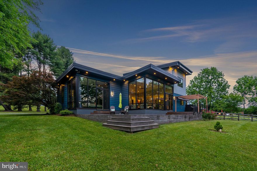 Welcome to this stunning contemporary home on over 5 gorgeous acres in Charlestown Twp. Move right in time to enjoy the gorgeous pool and grounds this home has to offer. Built-in 2016 with commercial-grade materials, this home has been built to last. Enter through the front door and you will be taken with the amazing views through the custom commercial glass wall system in the living room complete with exterior power shade. Marvin Ultrex fiberglass doors and windows throughout the home. The living room is open to the chef's kitchen complete with Thermador appliances, custom cabinetry, and gorgeous designer countertops including a walk-in pantry. The first floor has Mirage white oak quarter-sawn flooring in the living room and kitchen, and radiant floor heat throughout. Tall ceilings and custom 8 ft interior doors. A powder room is off of the living room. An 800 Sqft. Cumaru deck located off the living room, kitchen, and main bedroom provides the perfect spot for summer entertaining. Feel like you are sleeping outdoors in the first-floor primary bedroom with floor-to-ceiling windows. The luxurious primary bathroom feels like a spa with a large soaking tub, stand-up shower, two large vanities with plenty of storage space, and finished with designer tile and lighting. The primary bedroom has a large walk-in closet with a custom closet system. Work from home with gorgeous views in the office located off of the living room. Just off the kitchen is a convenient mudroom with a dog wash station and a powder room with easy access to the pool and yard. The laundry is also located on this level.

Walk up the custom-built staircase to the second floor with a huge bonus room and two additional bedrooms. A full bathroom services the two bedrooms on this floor. Second-floor design easily allows for an additional fourth bedroom and bathroom. The septic system is designed for 4 bedrooms.

The show-stopping grounds with 5-plus acres and a saltwater pool are truly an entertainer's dream. Enjoy summer evenings with amazing views and privacy. The pool has been redone with new plaster, filter, and heating equipment. The yard has been extensively landscaped and meticulously maintained with over 30 new plantings. A pool house is used for the storage of all your pool toys and pool furniture and is outfitted with electricity.

Additional details of this home are as follows: Geothermal with fresh air markup, Water softener, Moen automatic water shut off, No maintenance composite exterior, Insulated urethane wall panels, and custom siding over spray foamed walls, 2 car garage with Custom oversized garage doors, a Commercial grade roof system, Driveway was repaved, Shed with urethane walls and roof, Generator hookup with a transfer switch.