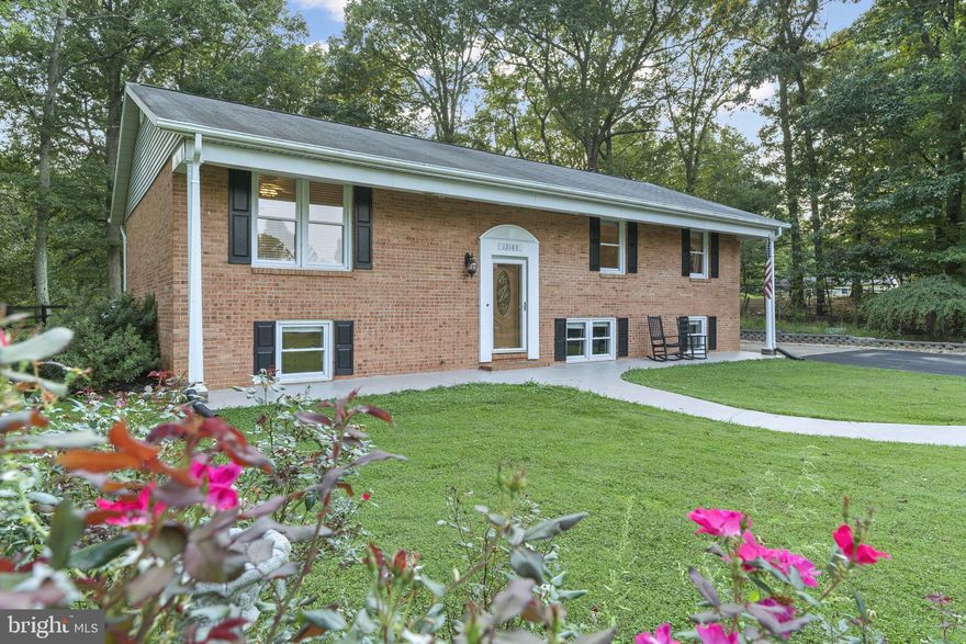 MOVE RIGHT IN!  This classic all-brick, low-maintenance home is ready for a new owner.  You will love the quiet setting and beautifully landscaped yard.  Relax on the front porch or enjoy the covered rear deck.  Come inside to a modern open floor plan, wood laminate flooring and new carpet in all the bedrooms and basement.  Large country-style kitchen features oak cabinets and peninsula island.  Three bedrooms on the main level including a master with a private bath.  The lower level is very light and bright featuring a secondary family room with a cozy brick fireplace and wood-burning stove.  There is potential for a 4th bedroom or home office on the lower level.  3rd full bath is partially finished and ready to complete.  Don't miss the large mudroom & laundry area with access to the backyard.  Conveniently located close to town.  Comcast available!  Backyard shed conveys.  Other sheds do NOT convey and will be moved from the property prior to closing. Ample room to build a detached garage or workshop.