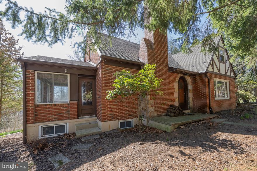 Welcome to this charming 4-bedroom, 2.5-bath Southern Lehigh brick Cape, set on a tranquil lot with timeless appeal and room to make it your own. The first-floor primary bedroom offers convenience and comfort, while beautiful hardwood floors run throughout the main living areas. The cozy family room features a wood-burning fireplace—perfect for relaxing evenings—and large windows that flood the space with natural light. The kitchen is equipped with stainless steel appliances, and the adjacent 3-season room invites you to enjoy the peaceful surroundings in any weather. A spacious 2-car garage completes the picture. Lovingly maintained, this home is ready for new owners to modernize and make it shine.Please take a moment to view the Matterport tour. Schedule your showing today!