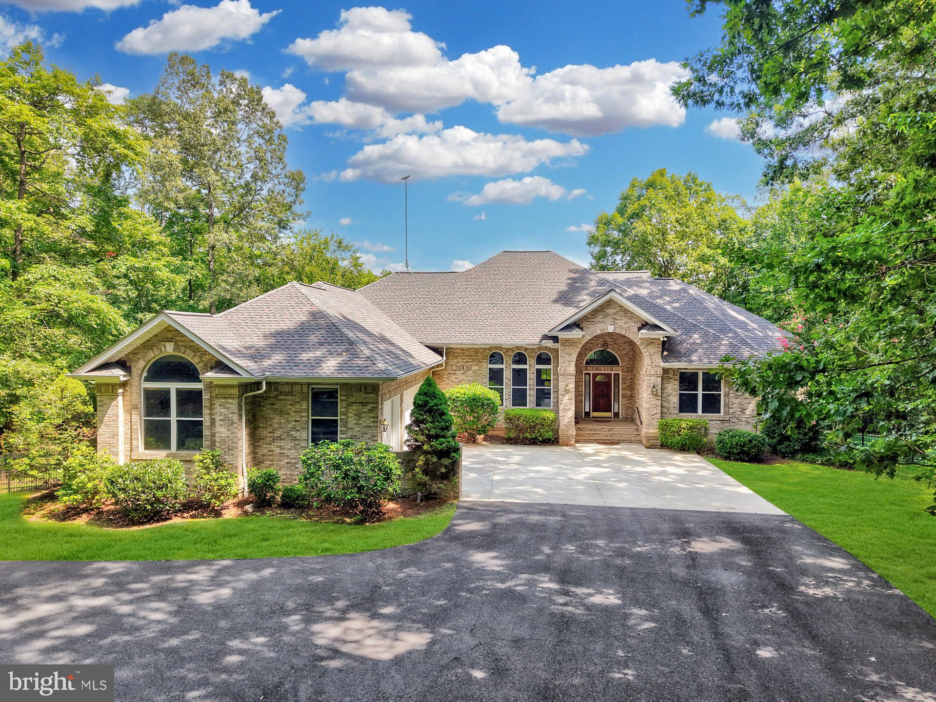 Welcome to 12587 Lake Coventry, a stunning lakeside retreat that offers the perfect blend of modern updates and serene natural beauty on over 10 private, wooded acres. Enjoy one of the largest, unobstructed lake views in the community, with direct access to the water for kayaking and scenic trails along the shoreline. The beautifully updated home features a fresh interior with new carpet and paint, a fully finished walkout basement, and an open layout ideal for entertaining. The main level includes 4 spacious bedrooms and 3 full bathrooms, while the finished basement offers 1–2 additional (NTC) bedrooms, a full bath, and multiple recreation spaces—including a playroom, TV room, and large rec room that opens directly to the backyard and lake.
Outdoor living is equally impressive with a large screened porch overlooking the lake, a new deck, and two separately fenced yards, one with pet-friendly artificial grass. The home also features an added mudroom, paved gravel driveway, and updated fencing around both side yards. Major systems have been upgraded for peace of mind, including a new roof (2020), HVAC (2018), and some replacement windows (2024). Kitchen views are nothing short of spectacular, with ample space and natural light. Recent appliance upgrades include a new refrigerator, cooktop, washer, and dryer. Whether you're relaxing on the porch, enjoying the trails, or hosting guests in the expansive basement, this property offers the ultimate in privacy, comfort, and lakeside living. Book your tour today!