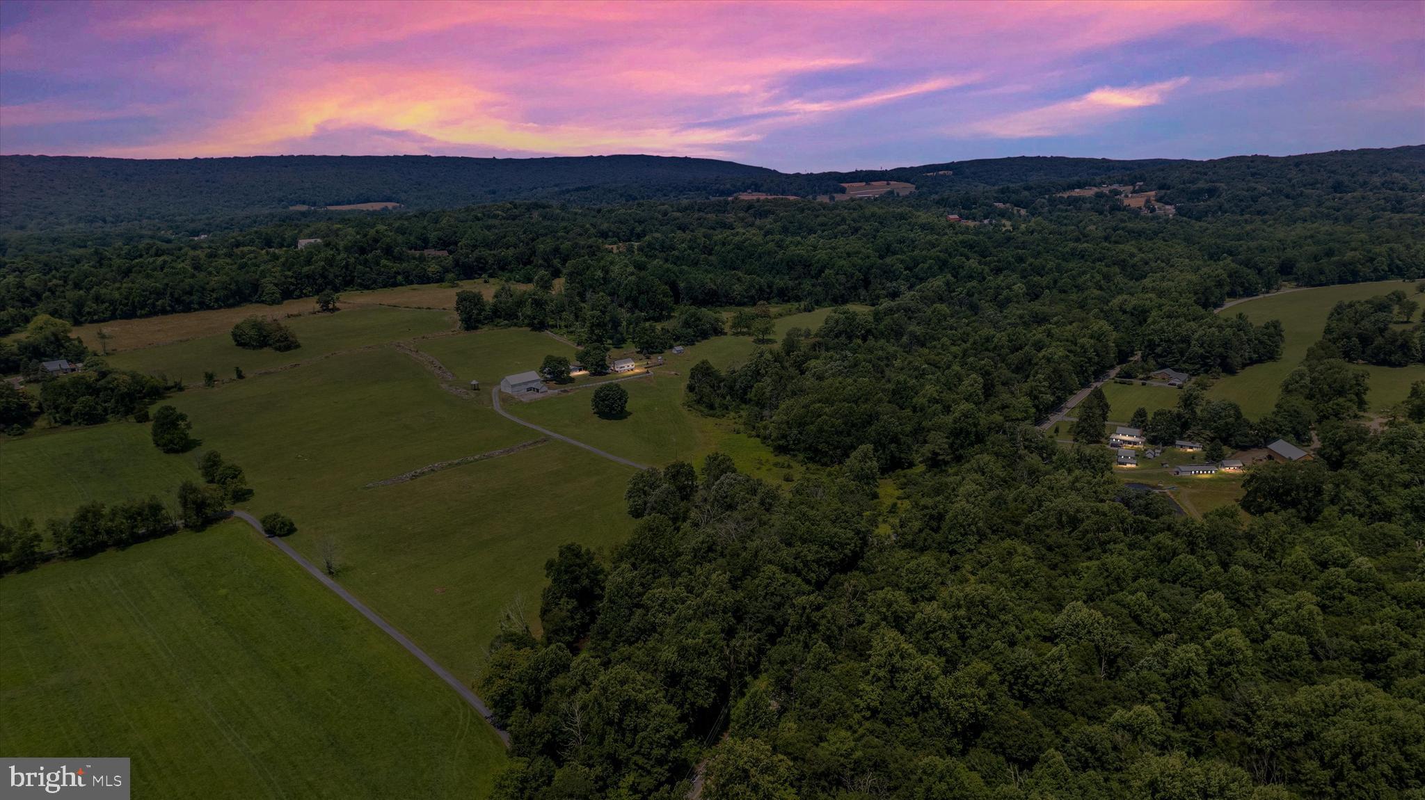 Beautiful and fruitful farm in Frederick county. Almost 80 acres of tillable, hay producing, fertile land with appropriate space and design for cattle and other livestock. 4 - 6 Horse stalls and flat rolling hills for equine. A quaint 2 bedroom - 1 bathroom farm house sits perched on a knoll on the West side of the property. The understated comfortable home has a full attic, a full basement with a cellar and potato bin. The oil burner is newer and so is the hot water heater. Large mature trees dance in the ever constant gentle breeze most appreciated from the sitting porch which is also under cover. In our minds, it's the perfect bean snapping spot where stories are told and lessons are learned. There is a detached garage, an equipment shed and a large bank barn with stalls. The floor, old original beams and structure appear to be in excellent condition. This property has a creek that runs along its boundary that runs healthy all year long. Most notable are the man-made stone fence line walls dividing paddocks and pasture that pull your attention to the old way of life the second you pull into the farm. They are a stunning sight. You'll have to cross the bridge over the creek to wind your way into this special well- loved farm and once you do, you may just not ever leave. Ag preservation estimates are available as well as tillable estimates. The family has proudly maintained this gorgeous homestead where Hereford beef cattle once roamed. They have a strict as is, where-is, in place. Middletown school district.