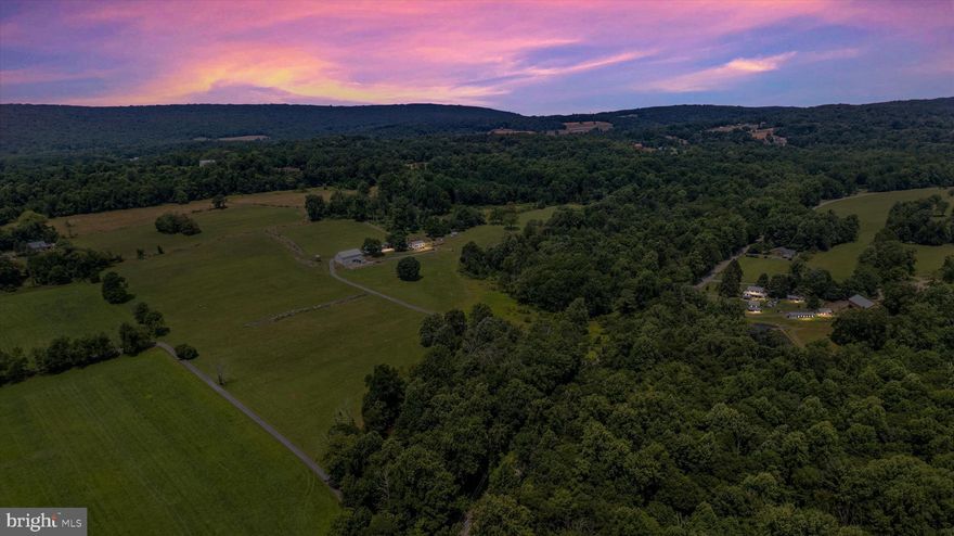 Beautiful and fruitful farm in Frederick county.  Almost 80 acres of tillable, hay producing, fertile land with appropriate space and design for cattle and other livestock.  4 - 6 Horse stalls and flat rolling hills for equine.  A quaint 2 bedroom - 1 bathroom farm house sits perched on a knoll on the West side of the property.  The understated comfortable home has a full attic, a full basement with a cellar and potato bin.  The oil burner is  newer and so is the hot water heater.  Large mature trees dance in the ever constant gentle breeze most appreciated from the sitting porch which is also under cover.  In our minds, it's the perfect bean snapping spot where stories are told and lessons are learned.  There is a detached garage, an equipment shed and a large bank barn with stalls.   The floor, old original beams and structure appear to be in excellent condition. This property has a creek that runs along its boundary that runs healthy all year long.  Most notable are the man-made stone fence line walls dividing paddocks and pasture that pull your attention to the old way of life the second you pull into the farm.   They are a stunning sight.   You'll have to cross the bridge over the creek to wind your way into this special well- loved farm and once you do, you may just not ever leave.  Ag preservation estimates are available as well as tillable estimates.  The family has proudly maintained this gorgeous homestead where Hereford beef cattle once roamed.  They have a strict as is, where-is, in place.  Middletown school district.