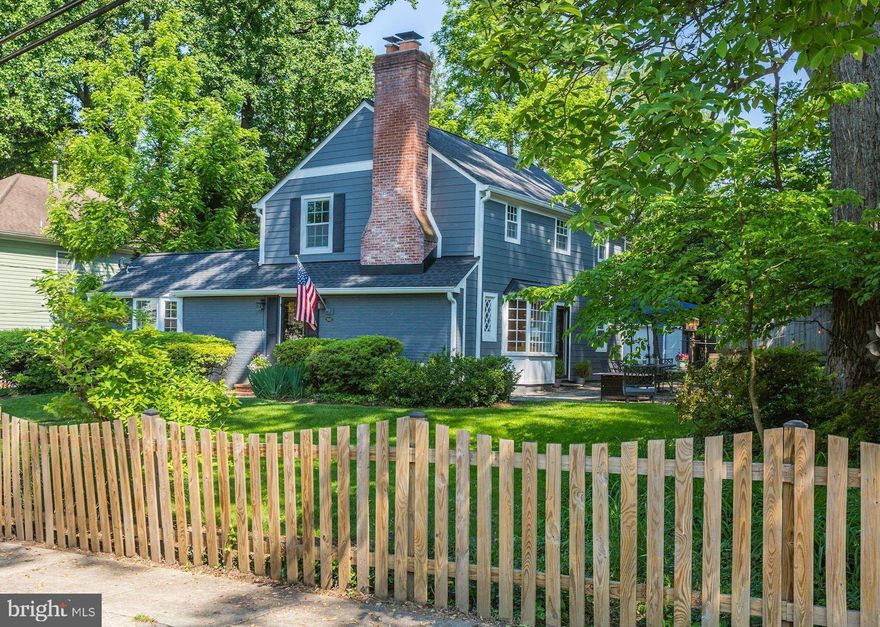 A rare opportunity awaits with this captivating 1940's jewel nestled on a sidewalk-lined street in the Town of Oakmont. Encompassed by a charming picket fence, the 1/4 acre lot boasts enchanting cottage gardens, a flagstone patio, lush green expanses, a child's playhouse, and mature trees and shrubbery. The interior offers timeless elegance, a refreshing floor plan, and beautiful sun-kissed spaces. Bay windows, random width heart pine flooring, and custom built-ins enhance this magical four bedroom, three full bath home. Main level highlights include a spacious living room with wood burning fireplace, a separate dining room, a study or fifth bedroom with a newly renovated ensuite bathroom, an updated granite and stainless kitchen open to the family room, and access to the rear deck and grounds. The upper level features delightful ceiling geometry, an inviting owner's bedroom with tranquil views, two additional bedrooms, and an updated full hall bathroom. Downstairs, the fully finished lower level offers a large recreation room, a bedroom with an ensuite bathroom, a laundry room, ample storage options, and a separate entrance. A detached three-car garage provides wonderful studio and home office possibilities. Just moments to the neighborhood park, NIH, metro, YMCA, and downtown Bethesda, this location is superb. Hurry!