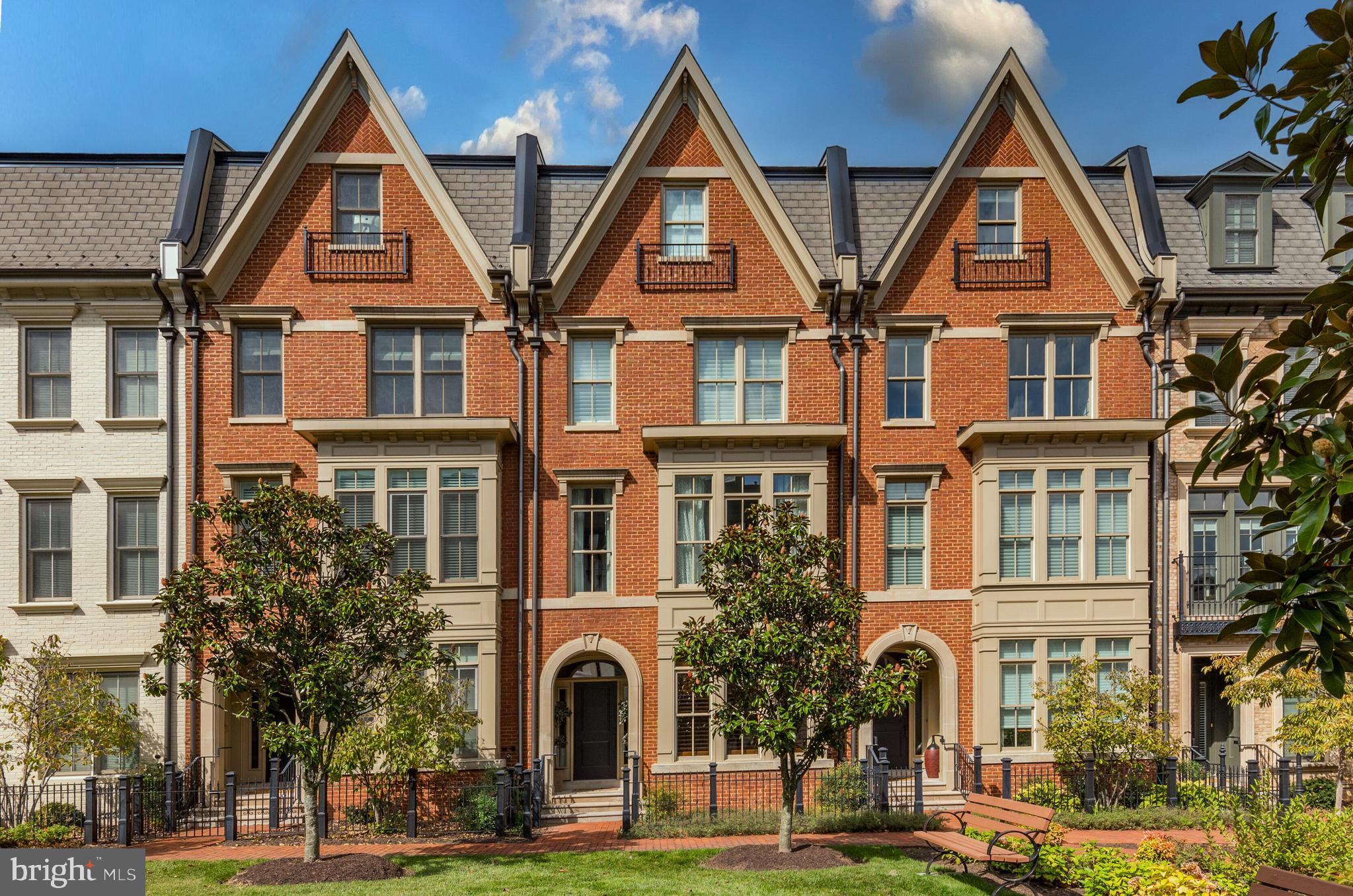 Price Improvement! Located in Symphony Park at Strathmore, this luxurious townhome community in North Bethesda offers a convenient location while providing a serene and tranquil setting. As you step inside, you'll be greeted by the elegance of hardwood floors that flow throughout the main living spaces, stunning millwork including crown molding throughout, and an elevator giving access to all four levels of the home. The entry level boasts a welcoming foyer, a bedroom with an ensuite bathroom, an office/library, and convenient access to the attached two-car garage, ensuring ease and comfort. The main level gourmet kitchen is a chef's dream, featuring a center island, high-end stainless steel appliances including a Viking six-burner gas range/oven with a hood, separate wall oven and microwave, refrigerator/freezer, and dishwasher. The ample cabinetry, quartz countertops, and tile backsplash create a functional and stylish space. The kitchen seamlessly opens up to the attached family room, which features a gas fireplace, custom built-ins, and access to the deck. The sun-filled combination dining room and formal living room offer an ideal entertaining space. Completing this level is a convenient powder bathroom.
Venture up to the third level, where you'll find two bedrooms, each with its own ensuite bathroom and the conveniently located laundry. The primary suite is a true oasis, boasting a spacious walk-in closet and a spa-like ensuite bathroom with a soaking tub, separate shower, and dual vanity. The fourth floor is a true entertainer's delight, featuring a stunning entertainment space with a full wet bar and an enormous outdoor rooftop terrace, perfect for hosting gatherings and enjoying the beautiful views. Additionally, there is a fourth bedroom with an ensuite bathroom, providing flexibility and versatility. This exceptional home is ideally located adjacent to the Strathmore Symphony Hall, and with Metro only a short distance away, commuting is a breeze. You'll also appreciate the close proximity to Pike & Rose, Whole Foods, Harris Teeter, Giant, Balducci's, and Downtown Bethesda, offering a wide array of shopping, dining, and entertainment options.