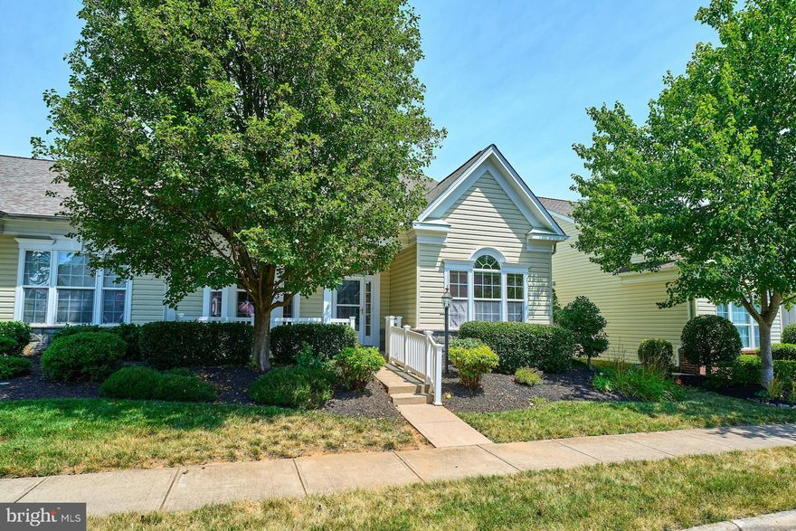 Nestled in the highly sought-after 55+ gated community of Dunbarton in Bristow, this lovely residence offers one-level living and is perfectly situated on a lovely, flat lot, complete with a rear-entry 1-car garage 
and a charming covered front porch that invites you inside.

As you step through the front door, you'll be greeted by fresh paint throughout, elegant crown and chair moldings, and stunning engineered hardwood floors in the main living areas. The bedrooms feature cozy Berber carpeting, adding to the home's warmth and charm.

The large, inviting foyer leads you to the main living spaces, including an expansive dining room that comfortably seats 10+ guests—ideal for entertaining. Continue through to the gourmet kitchen, which boasts a substantial breakfast bar that seats 4+, ample cabinet and counter space, beautiful granite countertops, stainless steel appliances, and pantry.   The adjacent breakfast room offers great views of the family room located just beyond the kitchen. The family room itself provides plenty of space, a ceiling fan, and access to a sunroom. This sunroom is a delightful retreat with 12x12 tile flooring, two full walls of windows,  a ceiling fan, and access to the backyard.

The large, light-filled primary bedroom can be found on the front of the home and includes Berber carpeting as well as a private ensuite bath with a walk-in shower that includes a built-in seat.  The secondary bedroom is equally bright and is nicely tucked away making this space very versatile. Additionally, the home features a large laundry/mud room with a wash sink and garage access.

The Dunbarton community offers a wealth of amenities, including a gym, billiard room, library, party room, indoor pool, and a variety of clubs and events throughout the week. Enjoy pickleball, tennis, and a wine-tasting club, as well as scenic walking and jogging paths. The community is secure with gated entrances and is conveniently close to shopping, dining, churches, the fire department, and Gateway Center. Just minutes away are UVA Health Hospital and various doctor’s offices.

This home provides the convenience of garage access during inclement weather, additional parking on the paved driveway, and guest parking in front of the home.