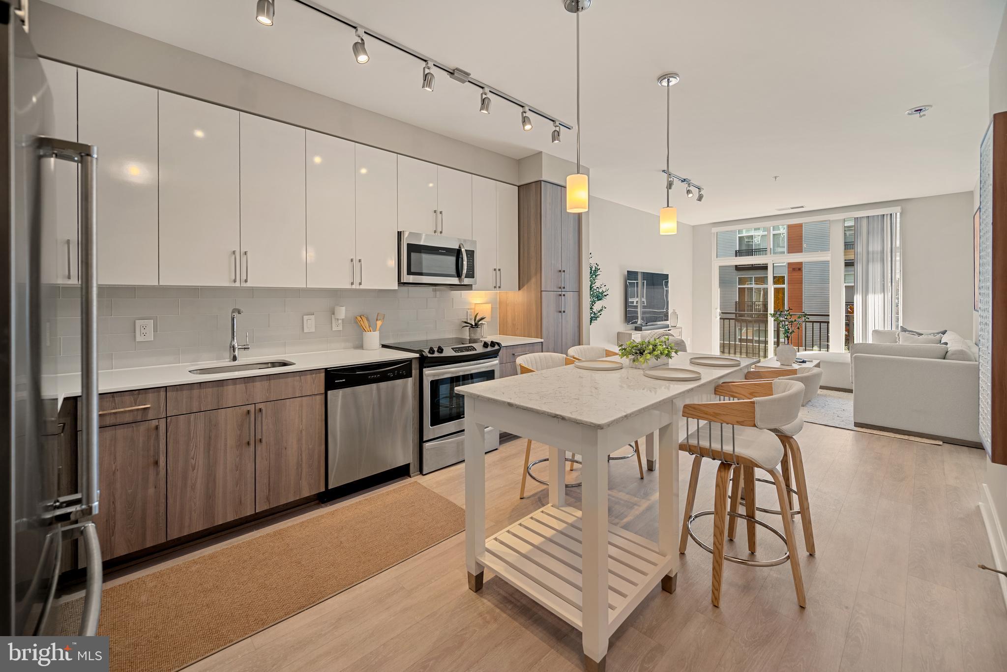 Welcome home to The Haven! This stunning, ultra-modern home features an open floorplan with gorgeous contemporary finishes and thoughtful storage - including a clever office nook created from a converted closet. The sophisticated, modern kitchen boasts on-trend two-tone cabinetry, stainless steel appliances, sleek granite countertops, and a classic subway tile backsplash. Luxury vinyl plank flooring leads you into the airy living room where a wall of windows fills the space with an abundance of natural light. The tranquil bedroom offers a zen-like retreat with ample closet space and a ceiling fan, while a spacious en suite bathroom features a wide vanity and stylish finishes. Step outside onto your private balcony to enjoy serene courtyard views while sipping your morning coffee or unwinding after a long day. In-unit laundry and reserved parking in a secure garage offer the height of convenience. Resort-like amenities in this desirable community include an on-site fitness center with separate yoga studio, outdoor pool, grill area, clubhouse, community and billiard rooms, pet spa station, temperature controlled secure bike storage, as well as a front desk concierge and 24/7 security including secure package delivery. Just minutes to National Harbor’s waterfront dining and shopping, Safeway, Target, Tanger Outlets, Old Town Alexandria, Joint Bases Andrews and Anacostia-Bolling, and The Pentagon. Quick access to I-495, I-95, I-295, and Indian Head Highway makes commuting and traveling around the DMV area a breeze. Schedule a private tour of your exquisite new home today!