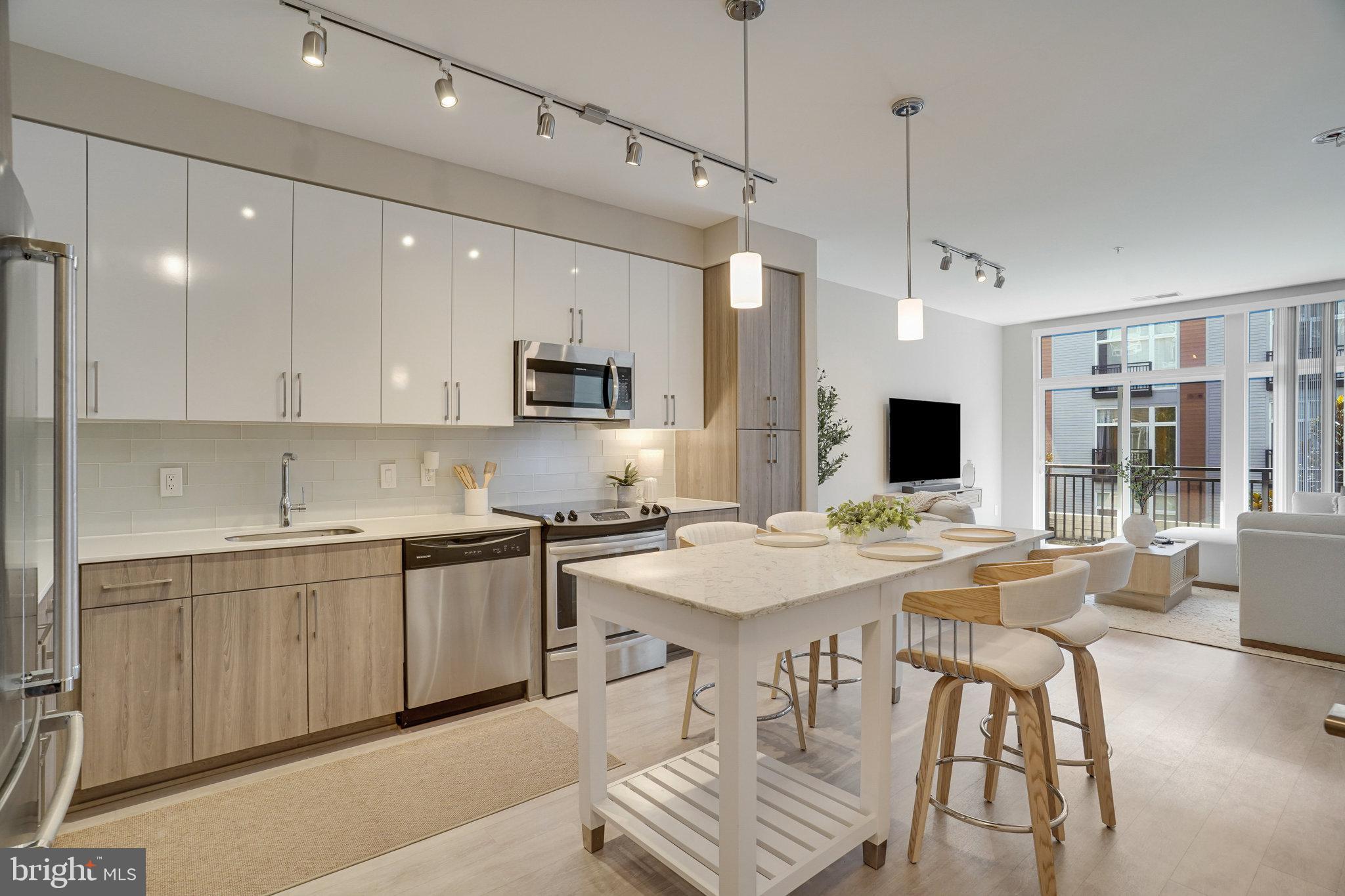 Welcome home to The Haven! This stunning, ultra-modern home features an open floorplan with gorgeous contemporary finishes and thoughtful storage - including a clever office nook created from a converted closet. The sophisticated, modern kitchen boasts on-trend two-tone cabinetry, stainless steel appliances, sleek granite countertops, and a classic subway tile backsplash. Luxury vinyl plank flooring leads you into the airy living room where a wall of windows fills the space with an abundance of natural light. The tranquil bedroom offers a zen-like retreat with ample closet space and a ceiling fan, while a spacious en suite bathroom features a wide vanity and stylish finishes. Step outside onto your private balcony to enjoy serene courtyard views while sipping your morning coffee or unwinding after a long day. In-unit laundry and reserved parking in a secure garage offer the height of convenience. Resort-like amenities in this desirable community include an on-site fitness center with separate yoga studio, outdoor pool, grill area, clubhouse, community and billiard rooms, pet spa station, temperature controlled secure bike storage, as well as a front desk concierge and 24/7 security including secure package delivery. Just minutes to National Harbor’s waterfront dining and shopping, Safeway, Target, Tanger Outlets, Old Town Alexandria, Joint Bases Andrews and Anacostia-Bolling, and The Pentagon. Quick access to I-495, I-95, I-295, and Indian Head Highway makes commuting and traveling around the DMV area a breeze. Schedule a private tour of your exquisite new home today!