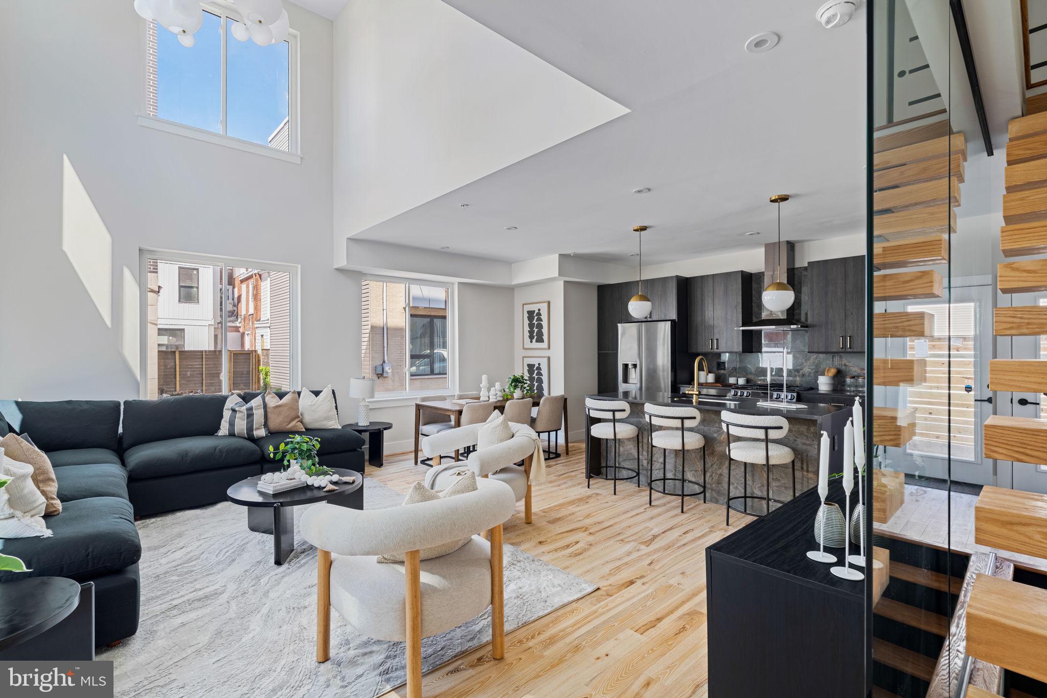 Introducing 2721 W. Flora Street! Situated on a corner lot and bordered by a cobblestone street, this remarkable new construction home impresses immediately with a vaulted 20-foot ceiling, white oak hardwood floors, signature chandelier, and ample space for entertainment or rest. The kitchen is highlighted by dark, polished quartz countertops, flat panel Carbone cabinets, and Marquina Gold backsplash tile and island backing. Off the kitchen, you'll enjoy access to rear-entry, roll-down gated vehicle parking.
Ascend the floating stairs, enclosed in a glass partition, to the first of four, above-grade bedrooms. This secondary bedroom suite features private patio, walk-in closet, and full, ensuite bath. Also on the second floor you'll find an cozy reading nook open to the living room below.
On the third floor, you'll find the primary bedroom suite. Ample room for a king sized bed with a second, private patio. Enormous, customized walk-in closet with shelving and storage. Spa-like primary bathroom with water closet, linen closet, soaking tub, double vanity, upgraded lighted mirror, and oversized walk-in shower with marble seat. Outside the primary bedroom suite you'll find laundry for convenience.
On the fourth floor, you'll find two additional bedrooms bifurcated by another full bathroom featuring shower/tub and double vanity. Walk in closet in each of the fourth floor bedrooms. A third private patio on this level as well. Modern kitchenette off these secondary bedrooms and en route to an impressive roof deck offering remarkable views of Center City Philadelphia and the Philadelphia Museum of Art. (You're going to enjoy watching 4th of July fireworks from here!)
Of course, don't miss the full, finished basement with a fourth full bathroom. Accented wall and tiled floor make this a perfect home gym, entertainment room, or even 5th bedroom suite.
Ten year tax abatement. Builder's warranty. You won't want to miss this rare find just minutes from Center City Philadelphia, Fairmount Park, and I-76.