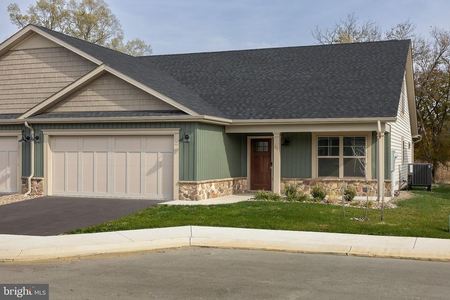 Construction of this home is complete!  Choose from 2 of these 4 builder incentives: free washer & dryer set from Spicher's up to a $2,500 value, $4,000 towards closing costs, $2,000 credit for new blinds from Budget Blinds of Martinsburg OR the first year of HOA dues paid!!   The back porch looks out into an open field currently.  Ready to move in now.  Pictures are of the actual home.   Mowing of your lawn, curbside trash pickup, road maintenance and snow removal of your driveway, sidewalks and the roads are all included as part of your HOA dues! 

The Villas at Warm Springs is Berkeley County's newest 55+ Community.  This quaint community is made up of only 14 Villa homes and offers a peaceful setting with sidewalks throughout.  It is conveniently located close to shopping, restaurants, medical facilities and has easy interstate access.   All villas come standard with a beautiful ceramic tile zero barrier Owner’s Shower, matte black lever door handles and fixtures, architectural grab bars in the Owner’s Suite bathroom and quartz or granite countertops throughout the kitchen and bathrooms.  Enjoy the ease of mobility with 36" doorways, no step thresholds and LVP throughout the main level.  A large laundry room with a sink is located immediately outside of the Owners Suite bedroom. Huge Bonus Room upstairs - perfect for guests, hobbies or storage! These features provide low maintenance living so you can enjoy accessibility throughout your new home.  The yard has been finished with lush sod, river rock landscaping and low maintenance shrubs.   Construction in the neighborhood is nearing completion, the roads will be finished with a top coat of asphalt in the near future.  Stop by and see if this new 55+ community would be the right move for you!