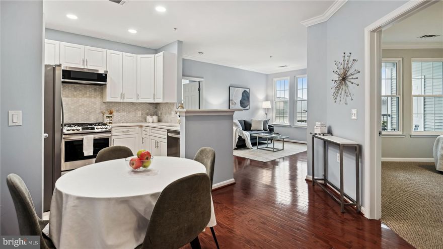 Gorgeous 2 bedroom, 1 bathroom home at The Grove, a luxury condo community in Arlington! The kitchen, bathroom, windows, washer/dryer, and paint were all updated in the last 3 years. This is unlike any other unit at The Grove! This private & serene urban oasis features a living room with gleaming, richly stained hardwood flooring & a gas fireplace with built-in shelving above. A rear door leads out to the private covered balcony with a storage closet & beautiful courtyard views from the 4th floor. The newly updated kitchen is accented white soft-close cabinetry with modern pulls, quartz countertops, a hexagon marble backsplash, newer stainless steel appliances, tile flooring, a large pantry, & a separate dining area! The primary bedroom features a renovated ensuite bathroom with a beautifully tiled shower with niche shelving, tile flooring, an oversized vanity with tons of storage space and drawer separators inside, recessed lighting, & a massive walk-in closet. The back hallway houses a laundry closet with a newer washer & dryer & a storage closet. A 2nd bedroom with a desk nook & two closets completes this home. Other home features include newer windows, TWO assigned parking spaces (very RARE for this community and for South Arlington) in the covered parking garage (#222 & #16). The Grove at Arlington features a state-of-the-art fitness center, community pool, courtyard with gas & charcoal grills, and a clubhouse with a media room for movie viewing, a cafe, billiard table, concierge service, a package room,  bike storage room & MORE!  Located just minutes from DC, The Grove is convenient to the Pentagon, Pentagon City, Shirlington, Del Ray, & Old Town Alexandria! There are numerous walking paths & bike trails nearby, and a dog park just down the street!