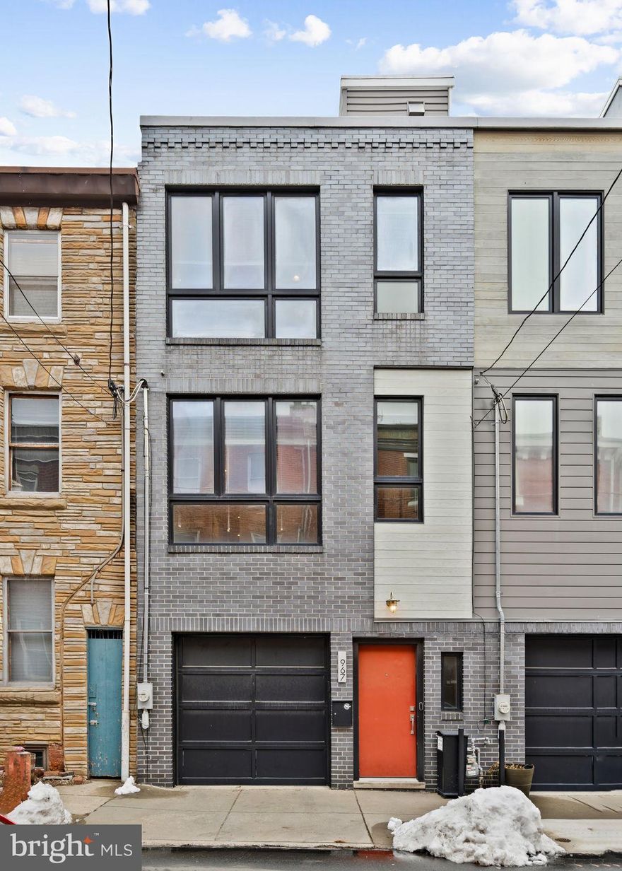 Northern Liberties - renowned for being stylish, eclectic, modern, creative, and full of sun - this home reflects just that. Welcome to 967 N Randolph, a unique contemporary built to bounce natural light from corner to corner, and featuring the highly coveted garage parking and backyard combination, Philadelphia's most sought after rarity. Enter through the one car garage, or front hall, to find 10ft ceilings in the kitchen and dining space and soaring two story ceilings above the main living space, drenched in sun from oversized windows and a skylight. The deluxe kitchen features Bosch appliances, two sinks, an oversized island, hidden microwave, all with quartzite countertops.  A half bath, storage closet, coat closet, and pantry complete the floor. Out back, the larger-than-most patio and paver yard gives you the option for greenery that every city dweller deserves, complete with a privacy fence. 

The second floor includes the primary bedroom, with floor to ceiling windows, a walk-in closet, and Scandinavian styled full bath with an enormous walk-in shower, complete with two shower heads. Laundry, and the 2nd bedroom with double door closets and vast backyard views is found at the rear. All bedrooms are similarly sized with great closets, with the primary being the largest. 

The 3rd and 4th bedrooms, both with larger-than-usual closets and oversized windows are on the 3rd floor, along with a luxe hall full bath with a spa tub and walk-in shower.  The bathrooms have Danze design fixtures. 

Finally, the pilot house, featuring a wall of windows and wet bar with storage, leads to the elegant roof deck. Because this property is not part of a community (no HOA!) the roofdeck offers more privacy, and your views are of the skyline, fabulous urban density and local greenery. 

The sellers have completed numerous upgrades and maintenance items including a new 3 zone HVAC system (2021), replaced fiberglass roofdeck (2023), replaced flat roof (2021) and many more. 

967 N Randolph is currently a blank slate, giving a similar energy to an art gallery space but also the likes of a cozy home, and with the right touches, it can comfortably be both. Make your appointment today,  and enjoy everything Northern Liberties has to offer!