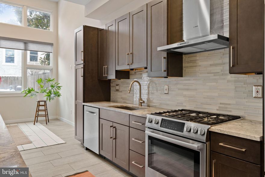 Northern Liberties - renowned for being stylish, eclectic, modern, creative, and full of sun - this home reflects just that. Welcome to 967 N Randolph, a unique contemporary built to bounce natural light from corner to corner, and featuring the highly coveted garage parking and backyard combination, Philadelphia's most sought after rarity. Enter through the one car garage, or front hall, to find 10ft ceilings in the kitchen and dining space and soaring two story ceilings above the main living space, drenched in sun from oversized windows and a skylight. The deluxe kitchen features Bosch appliances, two sinks, an oversized island, hidden microwave, all with quartzite countertops.  A half bath, storage closet, coat closet, and pantry complete the floor. Out back, the larger-than-most patio and paver yard gives you the option for greenery that every city dweller deserves, complete with a privacy fence. 

The second floor includes the primary bedroom, with floor to ceiling windows, a walk-in closet, and Scandinavian styled full bath with an enormous walk-in shower, complete with two shower heads. Laundry, and the 2nd bedroom with double door closets and vast backyard views is found at the rear. All bedrooms are similarly sized with great closets, with the primary being the largest. 

The 3rd and 4th bedrooms, both with larger-than-usual closets and oversized windows are on the 3rd floor, along with a luxe hall full bath with a spa tub and walk-in shower.  The bathrooms have Danze design fixtures. 

Finally, the pilot house, featuring a wall of windows and wet bar with storage, leads to the elegant roof deck. Because this property is not part of a community (no HOA!) the roofdeck offers more privacy, and your views are of the skyline, fabulous urban density and local greenery. 

The sellers have completed numerous upgrades and maintenance items including a new 3 zone HVAC system (2021), replaced fiberglass roofdeck (2023), replaced flat roof (2021) and many more. 

967 N Randolph is currently a blank slate, giving a similar energy to an art gallery space but also the likes of a cozy home, and with the right touches, it can comfortably be both. Make your appointment today,  and enjoy everything Northern Liberties has to offer!