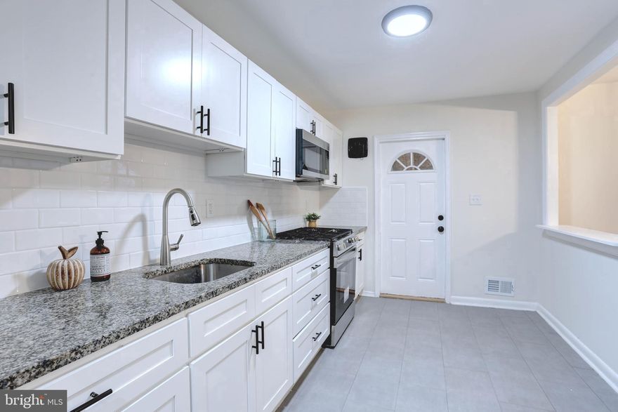 Listed Below Market Value!!! Welcome to 5751 Utrecht Road! This beautifully updated 3-bedroom, 1-bath home offers the perfect blend of charm and modern style. Step inside to gleaming refinished hardwood floors and a spacious living room that flows into a separate dining room — perfect for gatherings and everyday living. The updated kitchen features stainless steel appliances, white cabinetry, granite countertops, and a classic white subway tile backsplash. Upstairs, you’ll find three comfortable bedrooms and a fully renovated bath with a stunning tub/shower surround. The finished basement adds extra living or recreation space. Enjoy the fully fenced backyard — great for relaxing or entertaining. private 2 car parking pad. Conveniently located near I-95, I-895, and I-695, this Baltimore County home offers suburban comfort with city conveniences just minutes away!